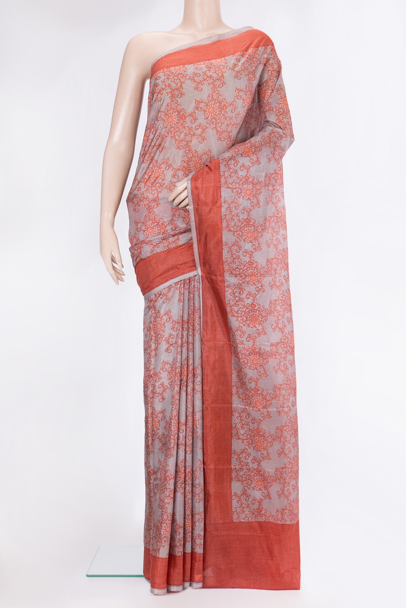 Grey Printed Silk Saree with Printed design on the body and Printed Border.  displayed on a mannequin