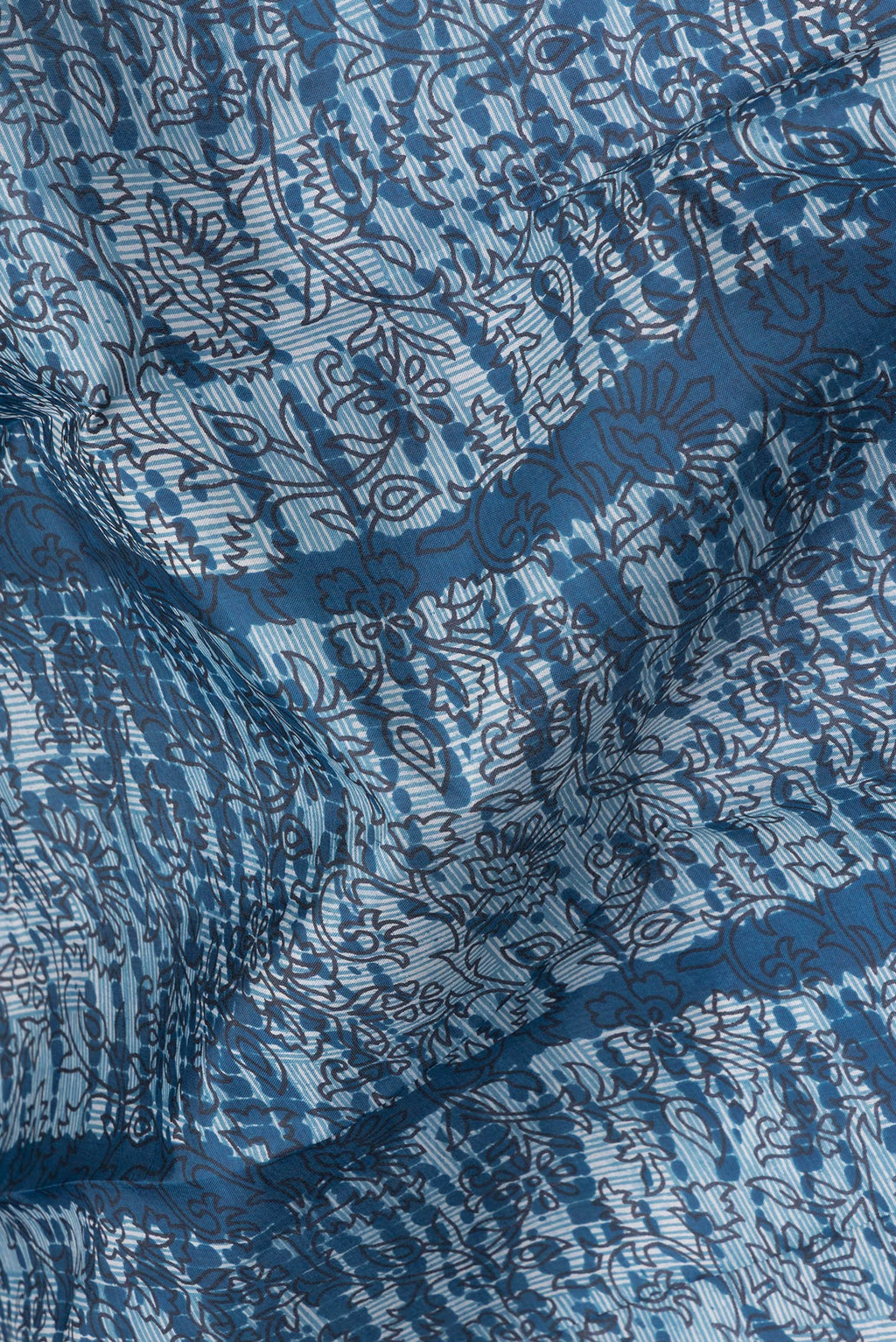 Close up of Peacock Blue Printed Silk Saree with Printed design on the body and Printed Border.  displaying folds