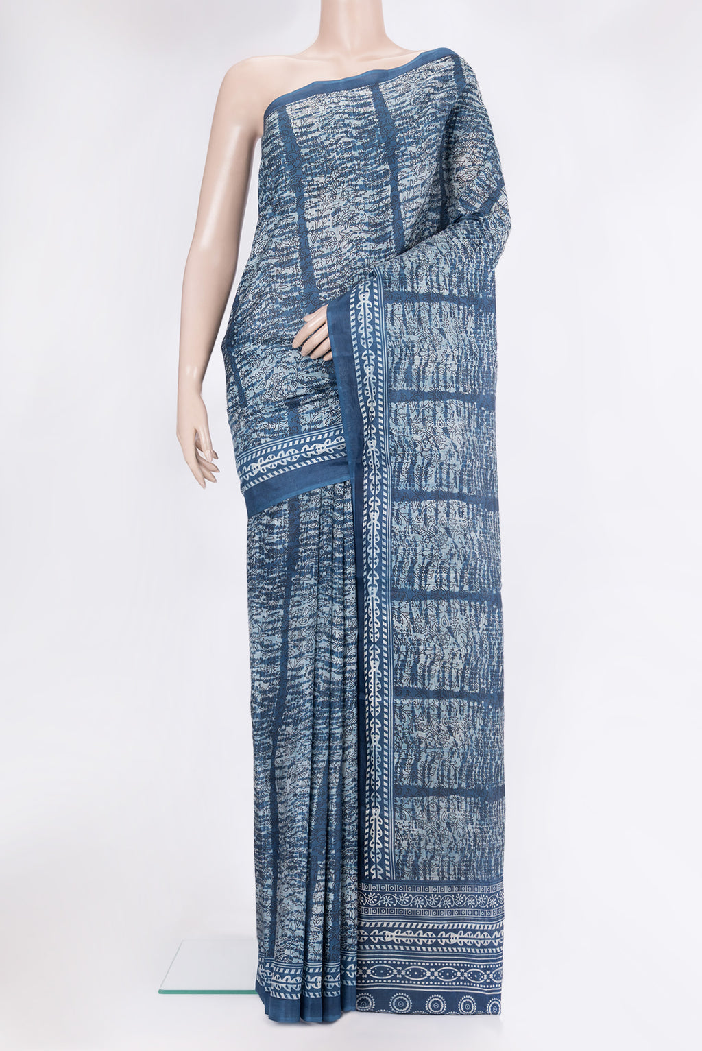 Peacock Blue Printed Silk Saree with Printed design on the body and Printed Border.  displayed on a mannequin
