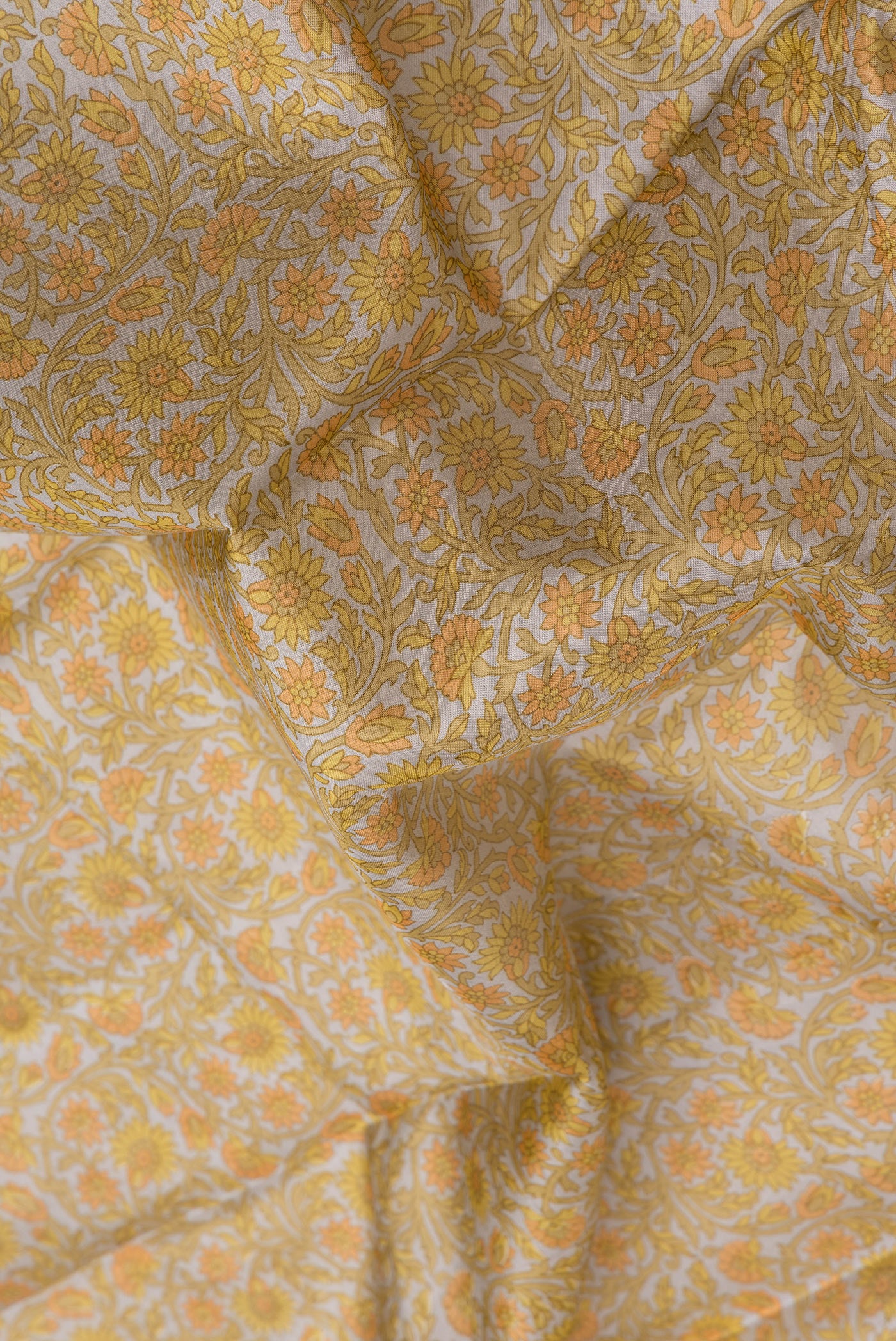 Close up of Grey Printed Silk Saree with Printed design on the body and Printed Border.  displaying folds