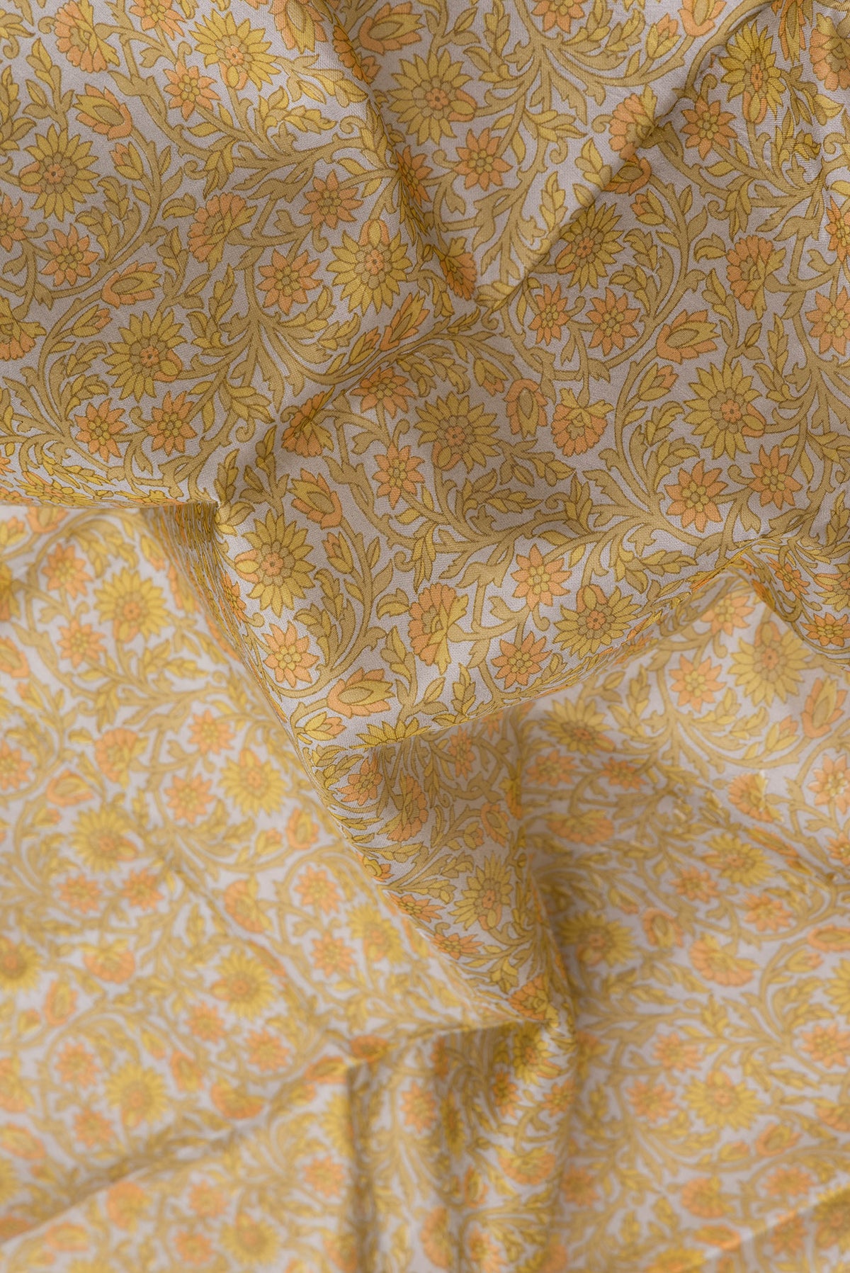 Close up of Grey Printed Silk Saree with Printed design on the body and Printed Border.  displaying folds