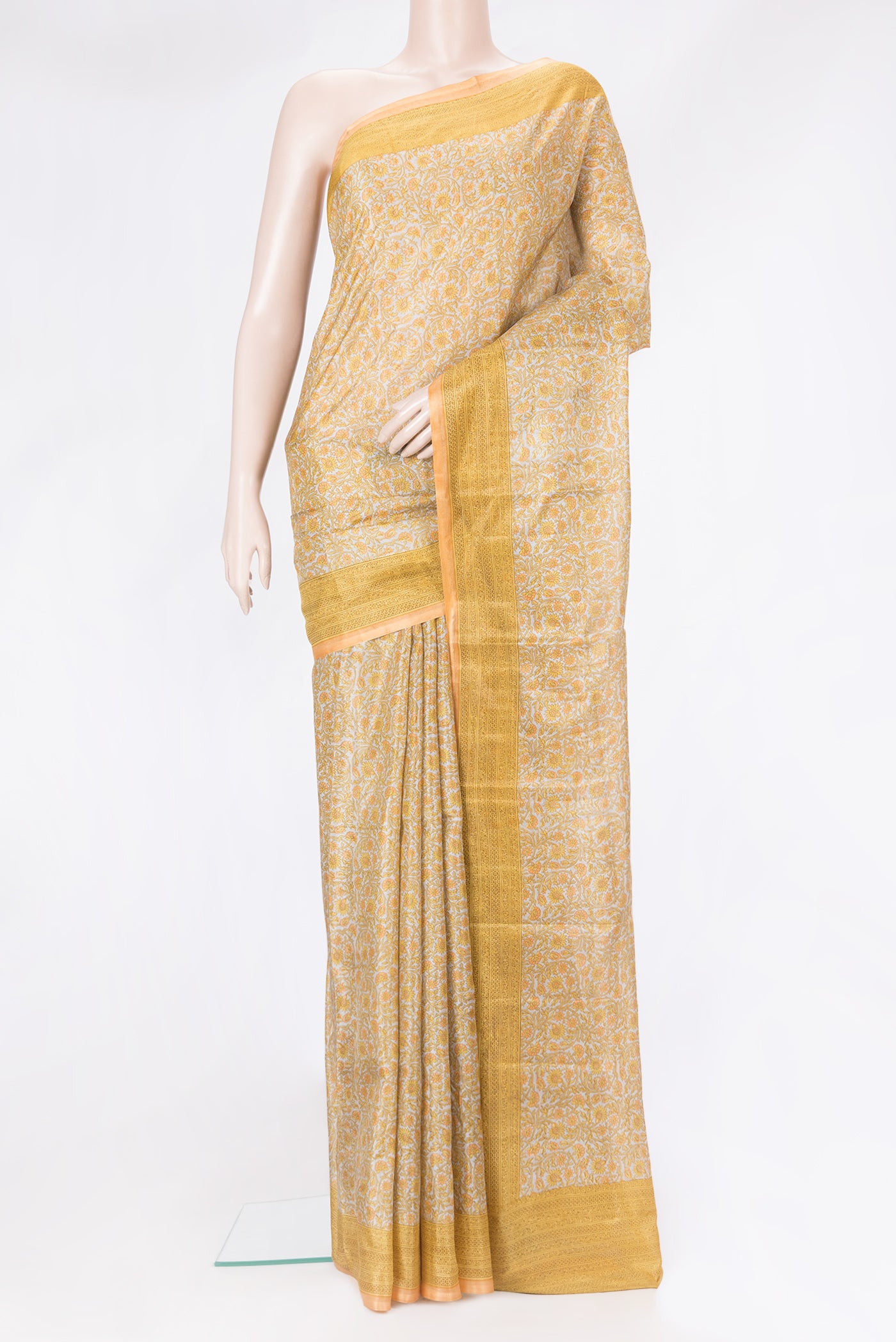 Grey Printed Silk Saree with Printed design on the body and Printed Border.  displayed on a mannequin