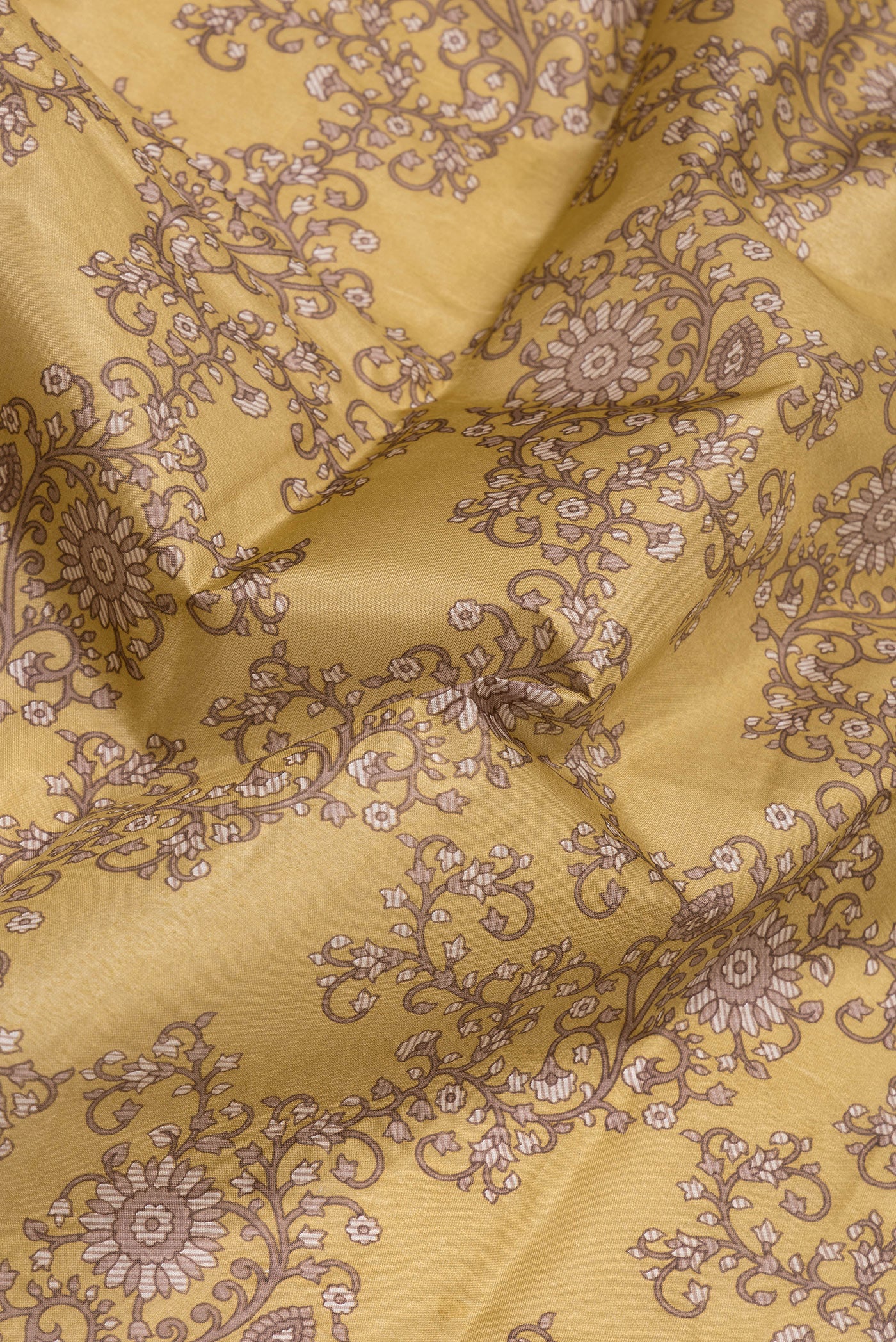 Close up of Gold Printed Silk Saree with Printed design on the body and Printed Border.  displaying folds