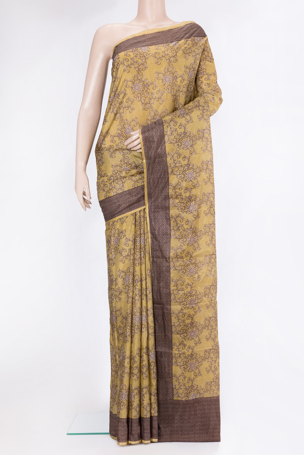 Gold Printed Silk Saree with Printed design on the body and Printed Border.  displayed on a mannequin