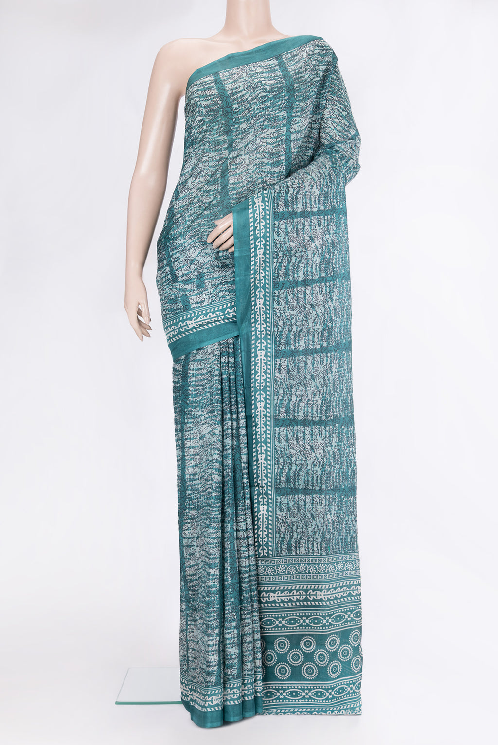 Peacock Blue Printed Silk Saree with Printed design on the body and Printed Border.  displayed on a mannequin