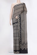 Black Printed Silk Saree with Printed design on the body and Printed Border.  displayed on a mannequin
