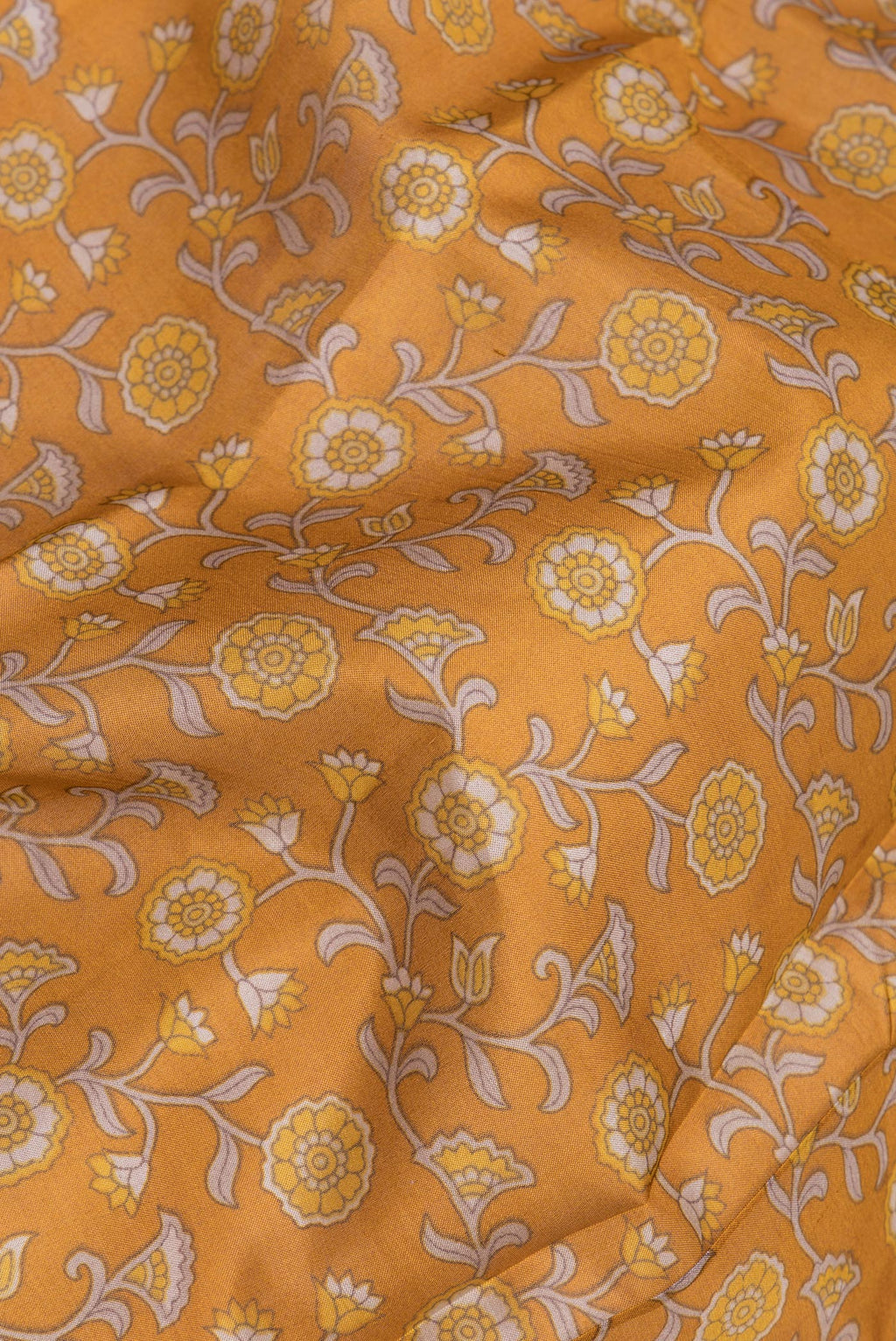 Close up of Mustard Printed Silk Saree with Printed design on the body and Printed Border.  displaying folds