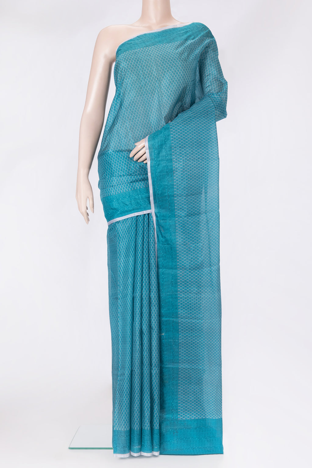 Peacock Blue Printed Silk Saree with Printed design on the body and Printed Border.  displayed on a mannequin