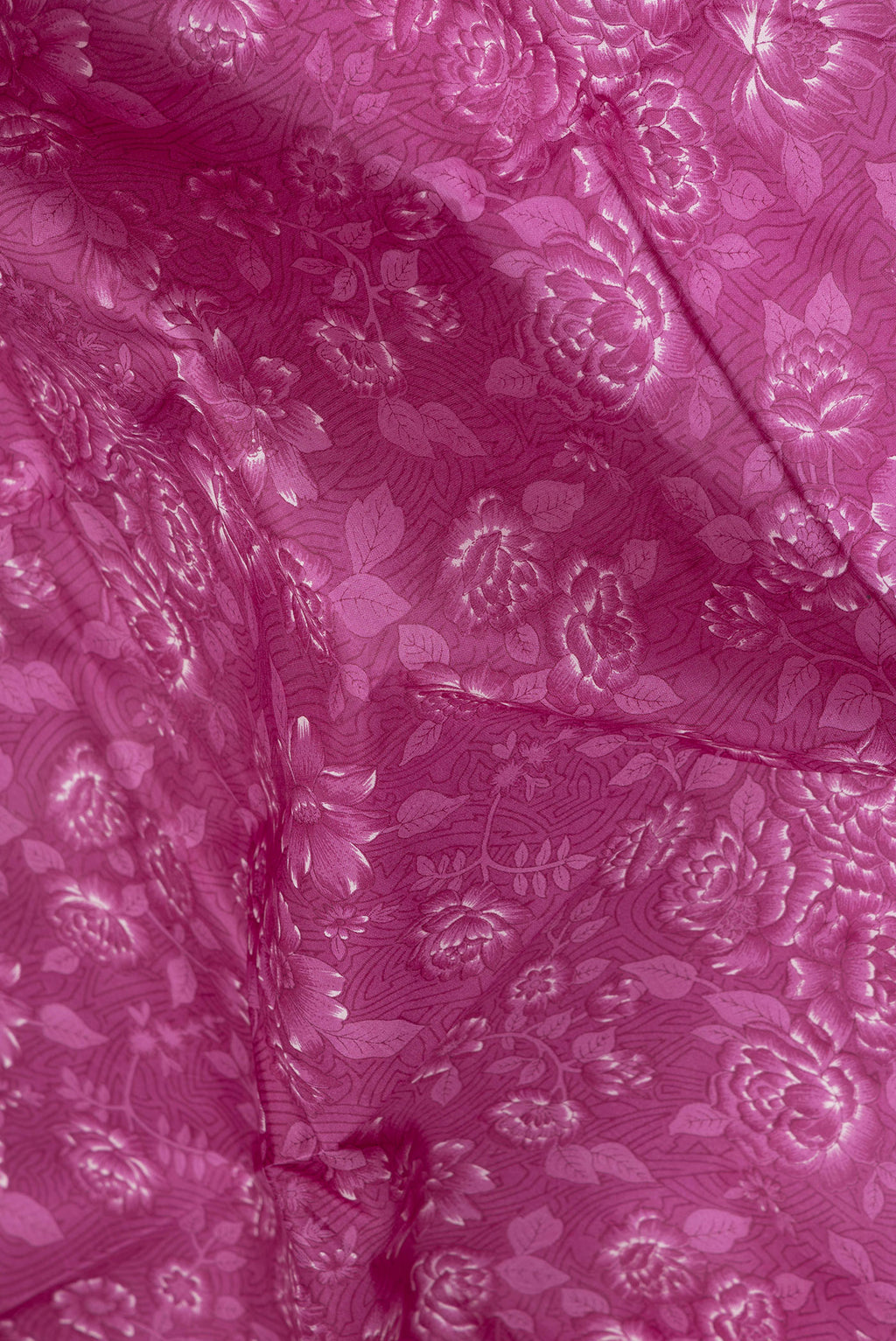 Close up of Magenta Printed Silk Saree with Printed design on the body and Printed Border.  displaying folds