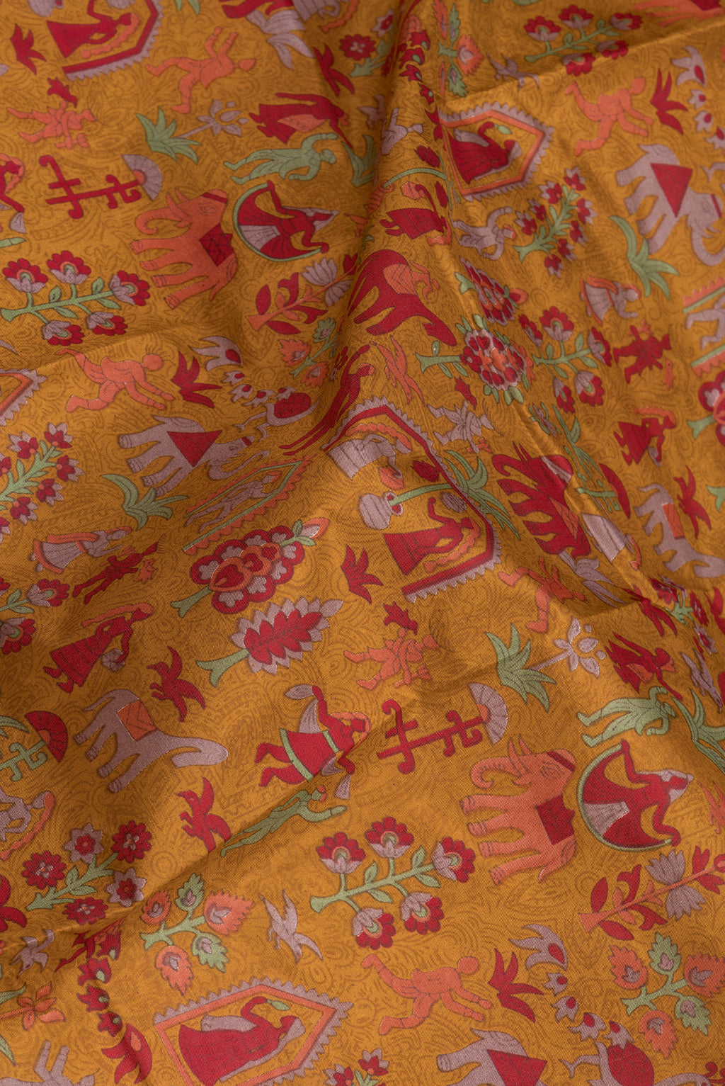 Close up of Mustard Printed Silk Saree with Printed design on the body and Printed Border.  displaying folds
