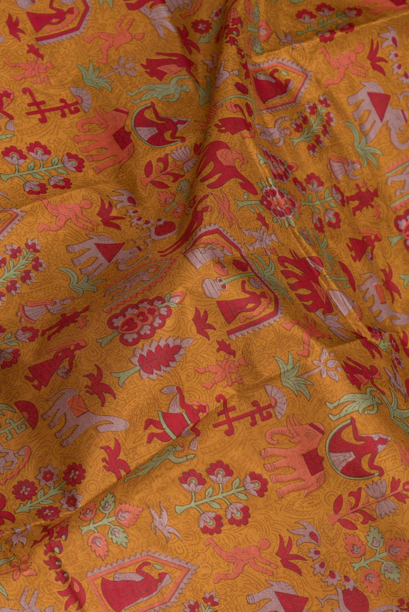 Close up of Mustard Printed Silk Saree with Printed design on the body and Printed Border.  displaying folds