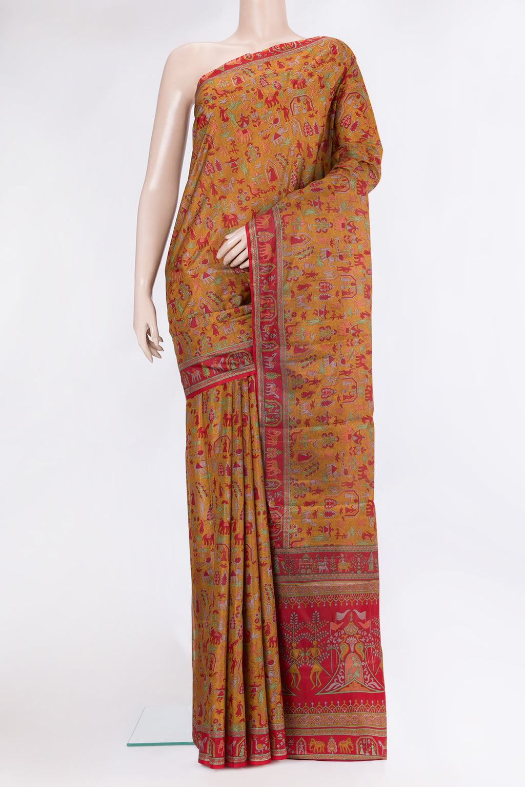 Mustard Printed Silk Saree with Printed design on the body and Printed Border.  displayed on a mannequin