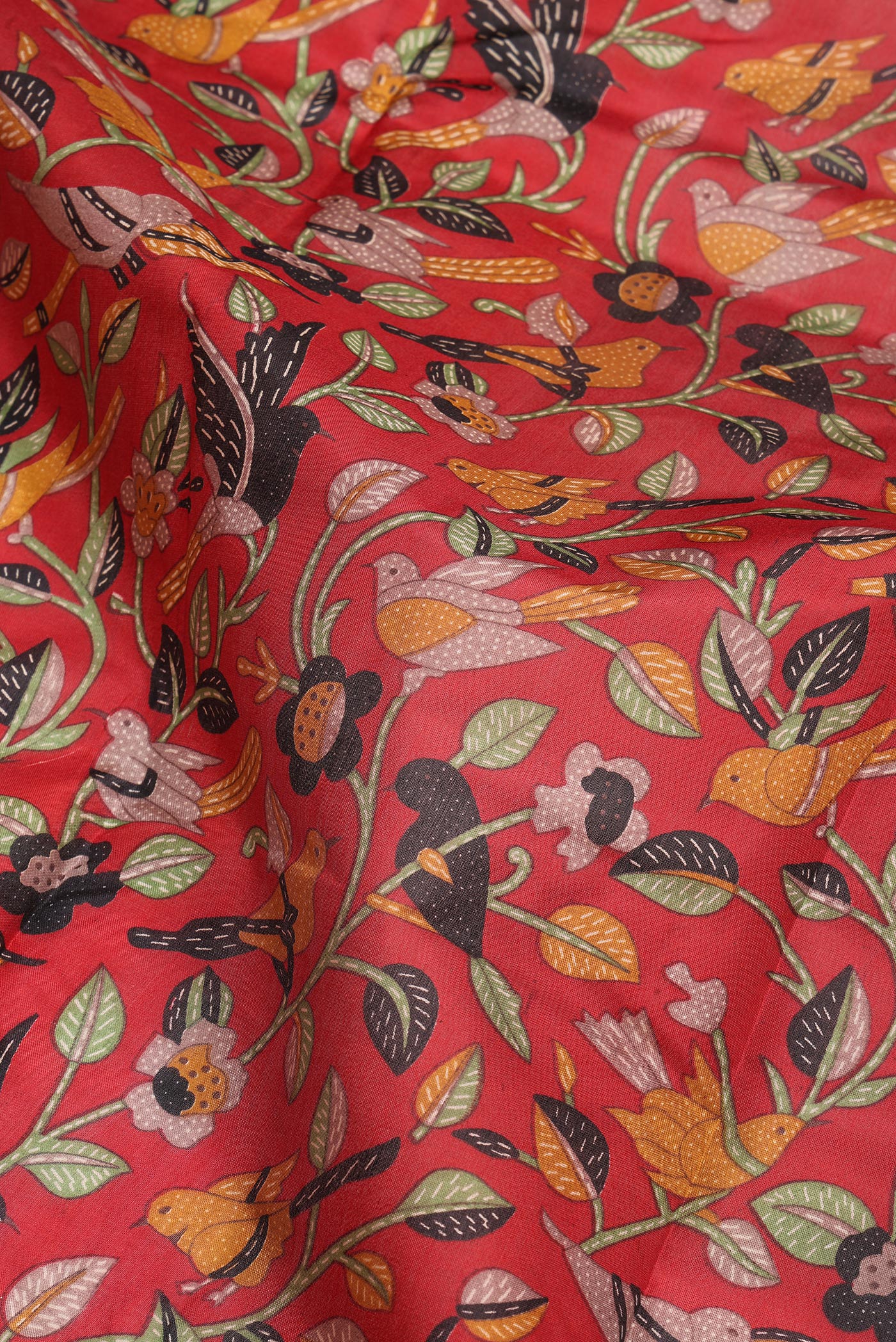 Close up of Maroon Printed Silk Saree with Printed design on the body and Printed Border.  displaying folds