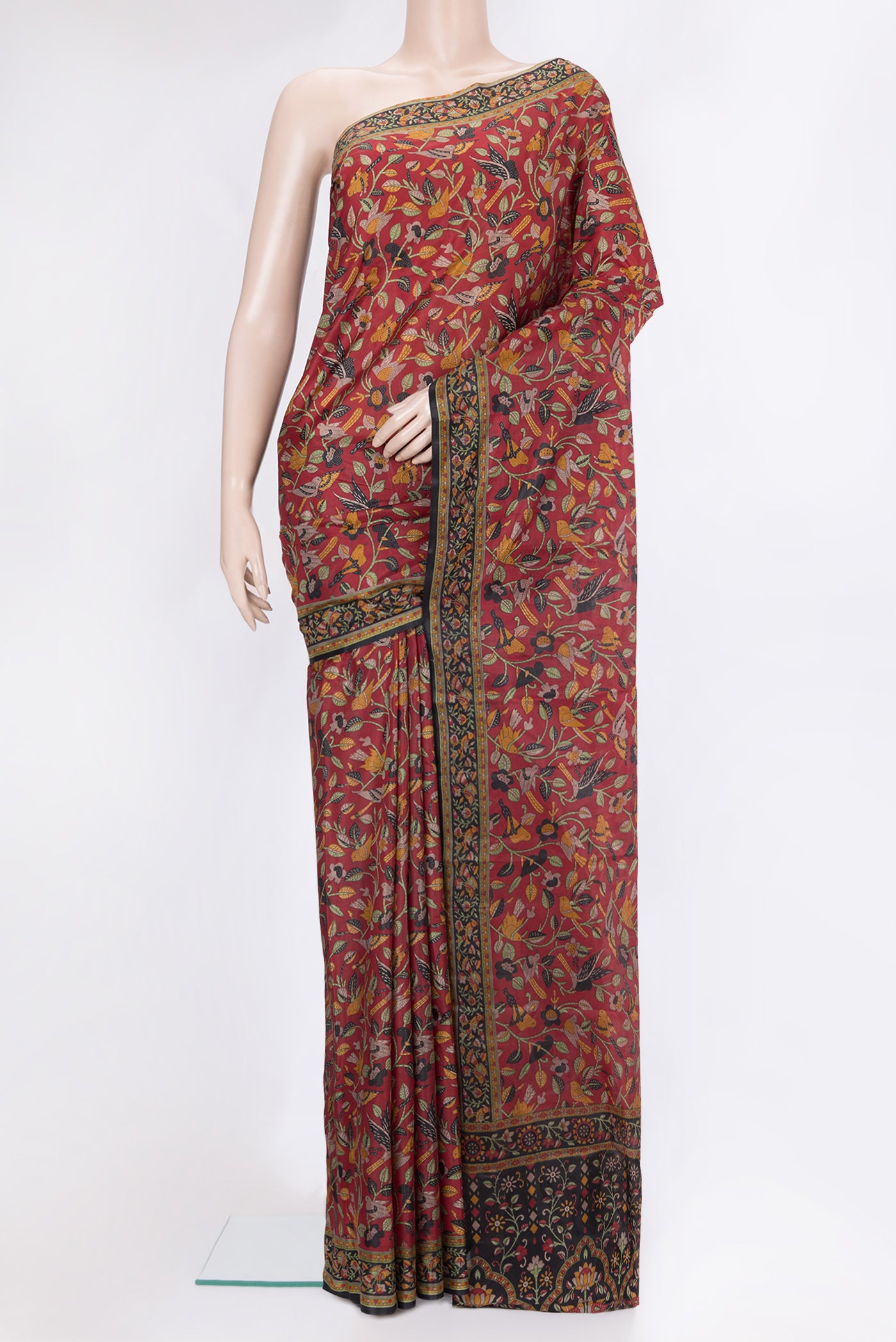 Maroon Printed Silk Saree with Printed design on the body and Printed Border.  displayed on a mannequin