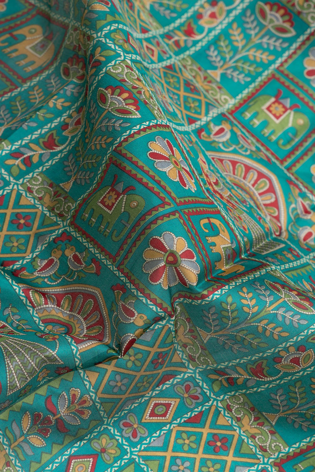 Close up of Green Dual Tone Tussar Silk Saree with Printed design on the body and Thread Border.  displaying folds