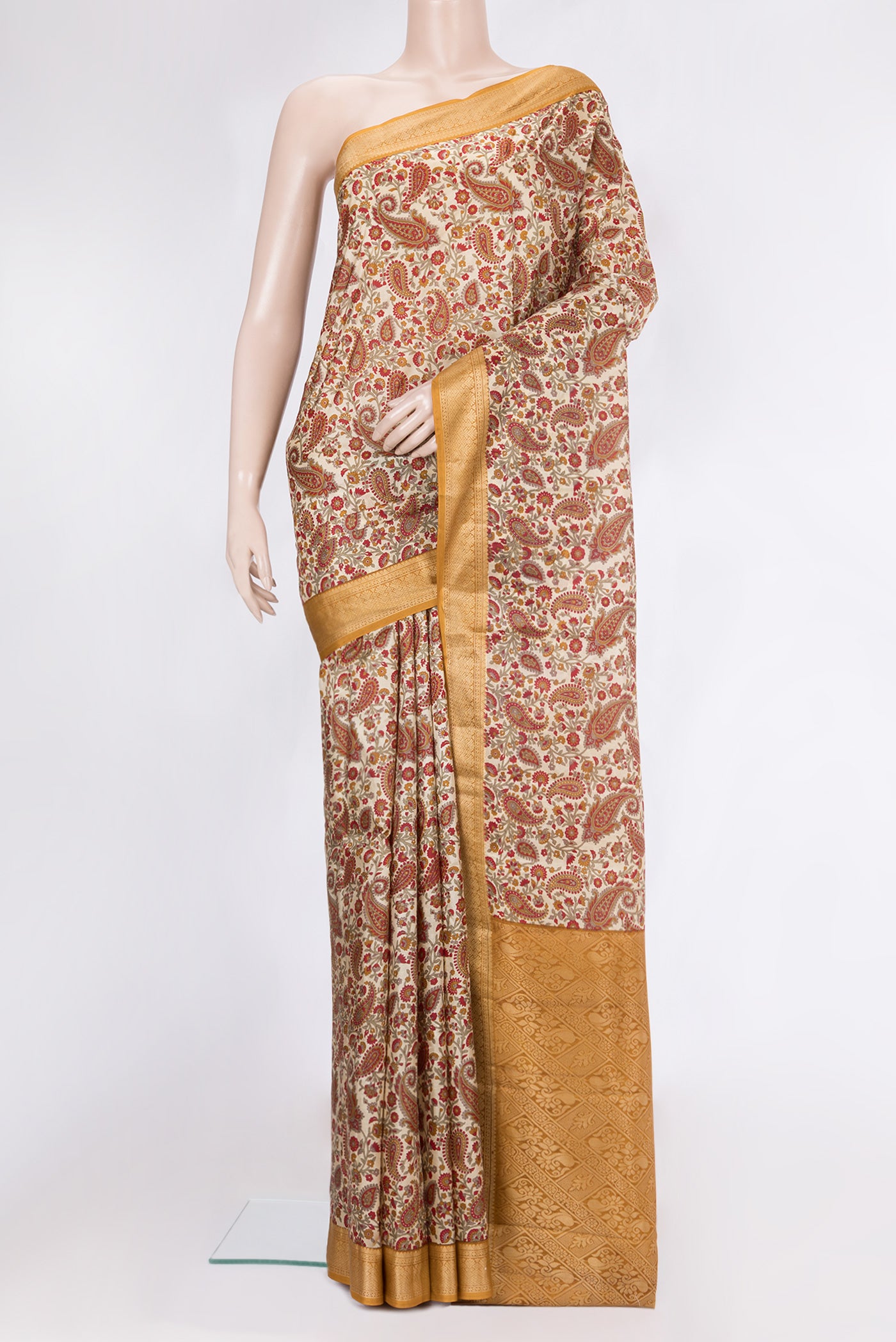 Beige Printed Silk Saree with Printed design on the body and Thread Border.  displayed on a mannequin