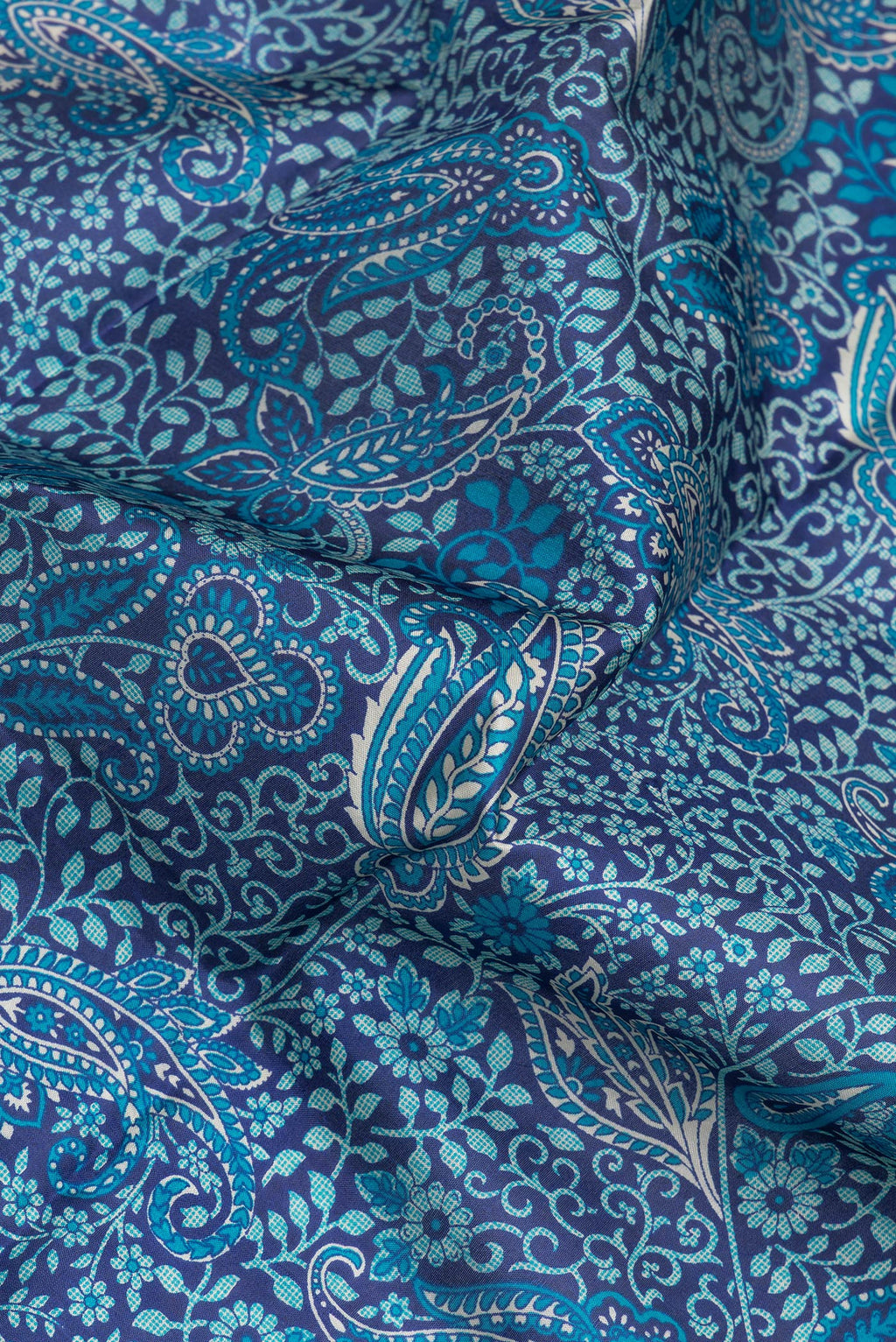 Close up of Navy Blue Printed Silk Saree with Printed design on the body and Thread Border.  displaying folds