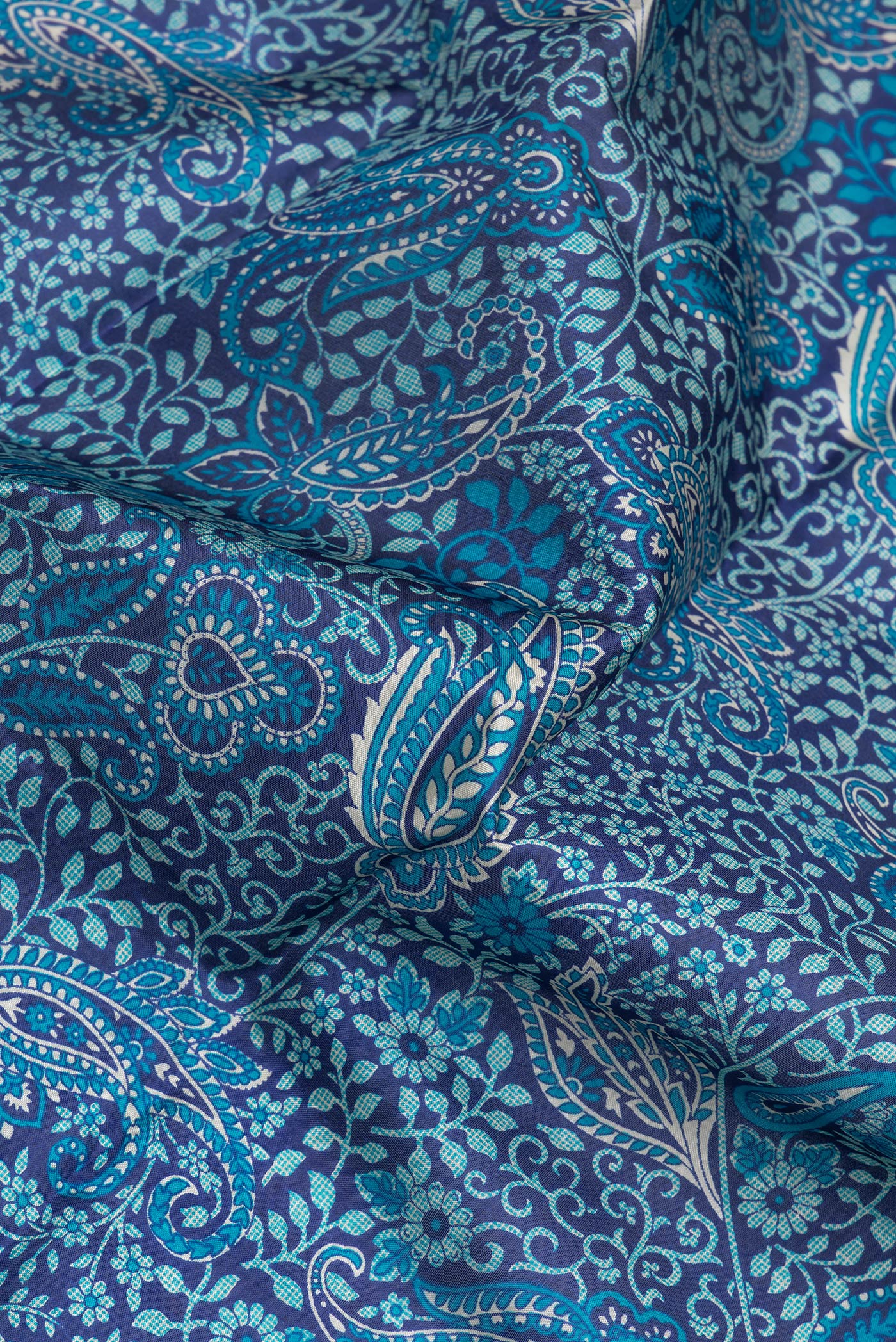 Close up of Navy Blue Printed Silk Saree with Printed design on the body and Thread Border.  displaying folds