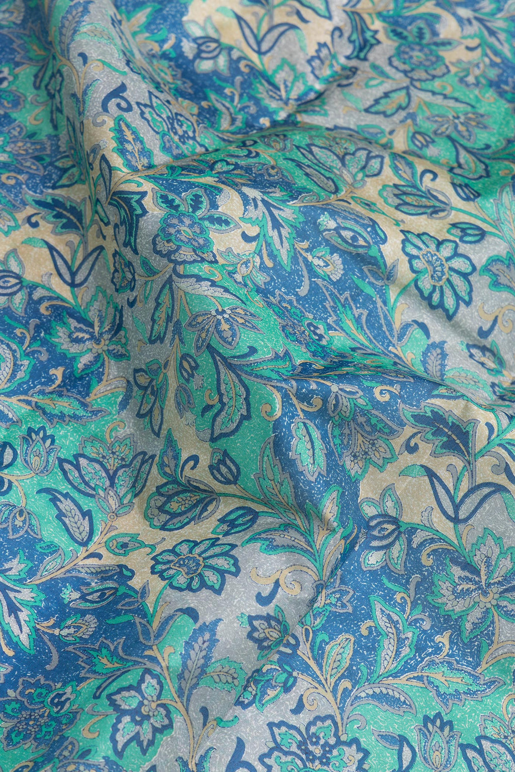 Close up of Peacock Blue Dual Tone Tussar Silk Saree with Printed design on the body and Printed Border.  displaying folds