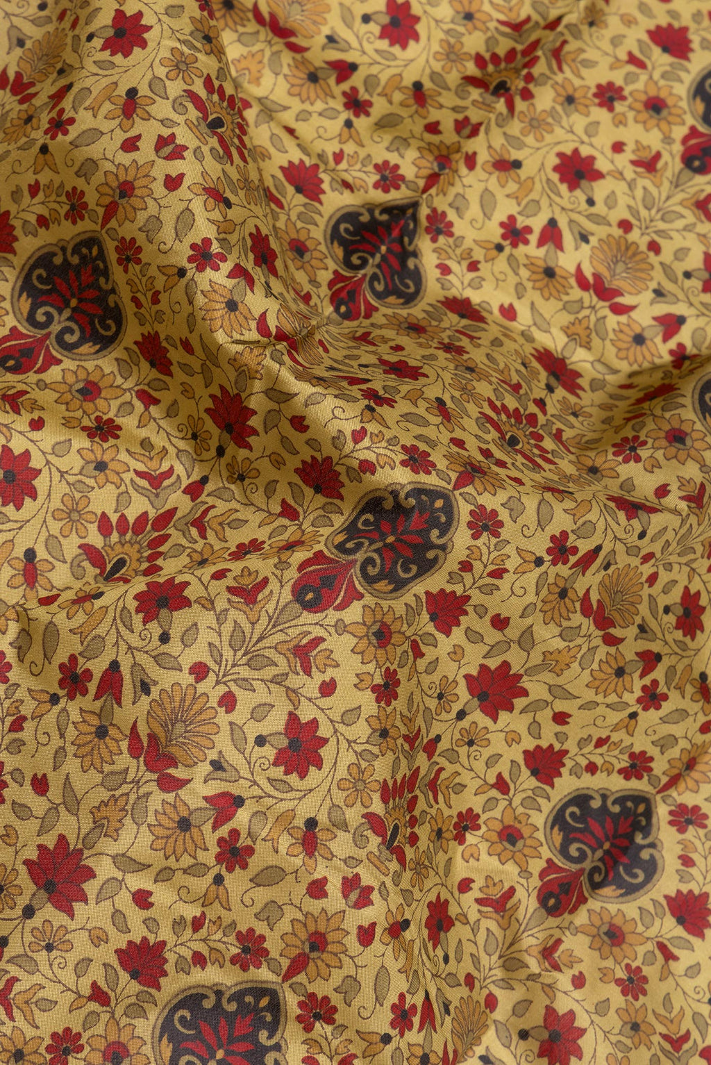 Close up of Golden Printed Silk Saree with Printed design on the body and Printed Border.  displaying folds