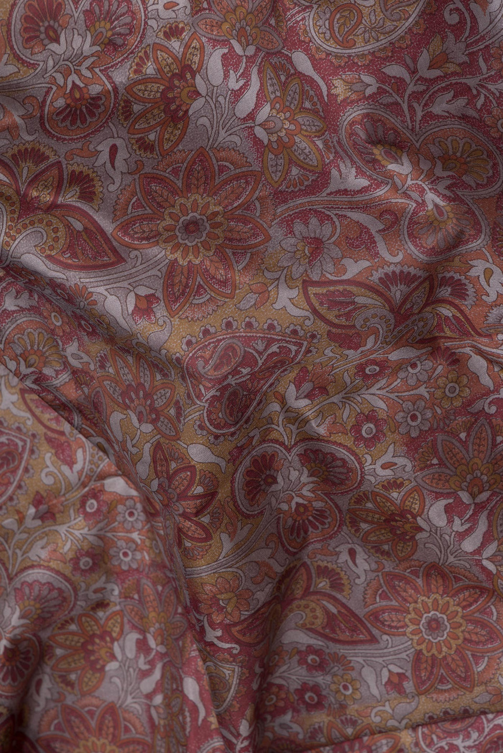 Close up of Brown Printed Silk Saree with Printed design on the body and Printed Border.  displaying folds