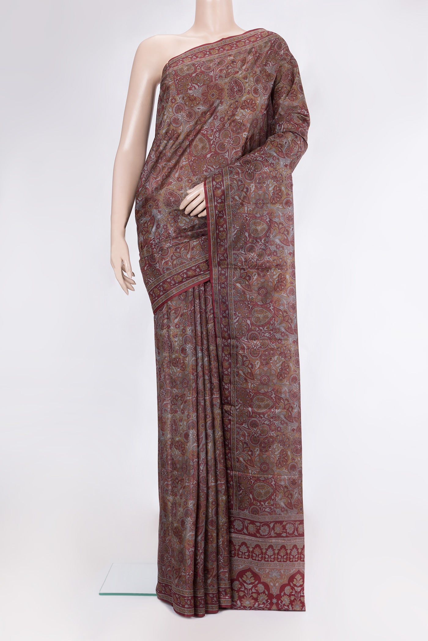 Brown Printed Silk Saree with Printed design on the body and Printed Border.  displayed on a mannequin
