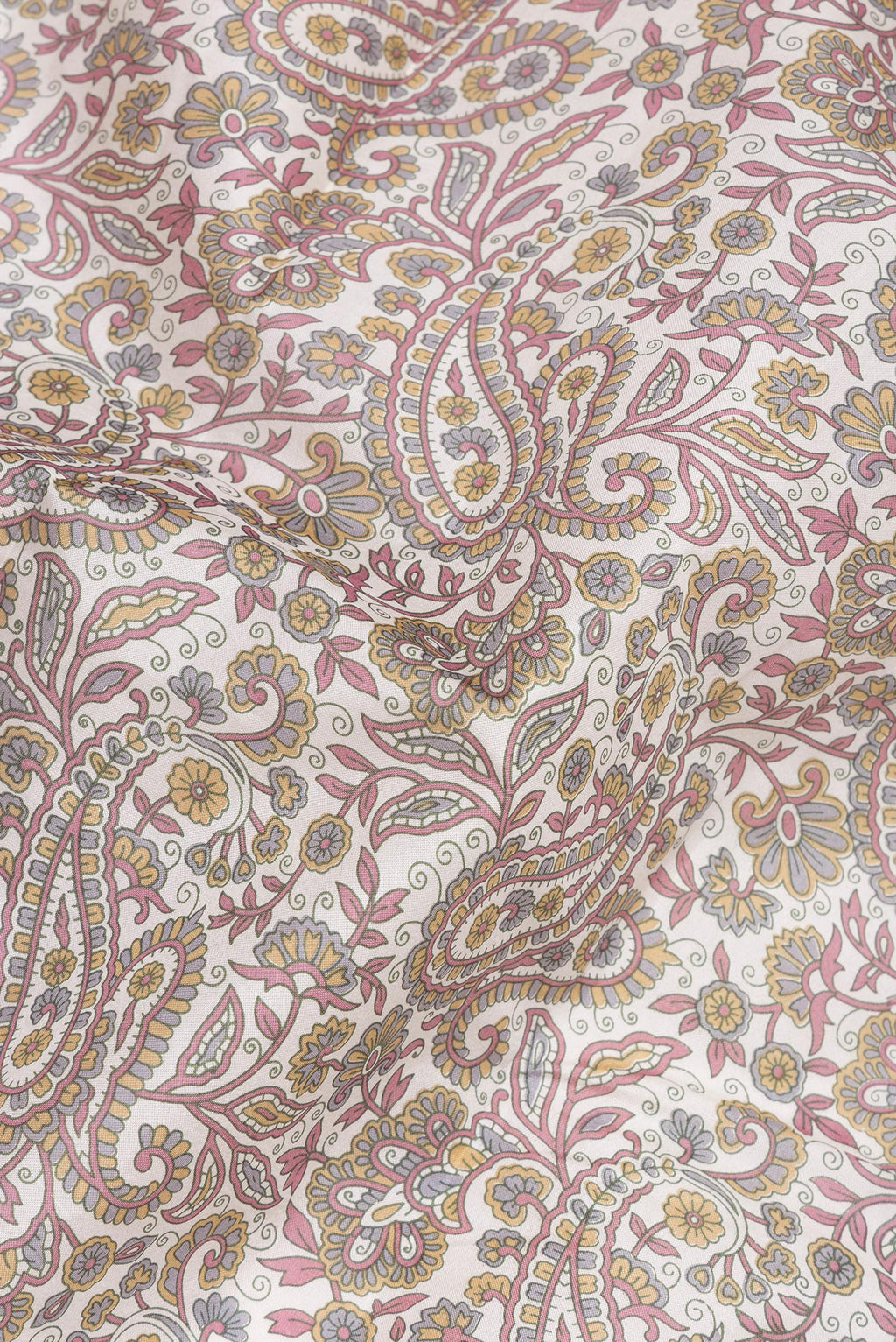 Close up of Off White Printed Silk Saree with Printed design on the body and Printed Border.  displaying folds
