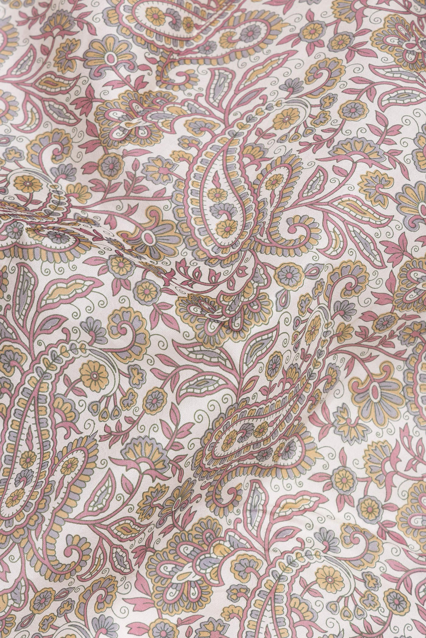 Close up of Off White Printed Silk Saree with Printed design on the body and Printed Border.  displaying folds