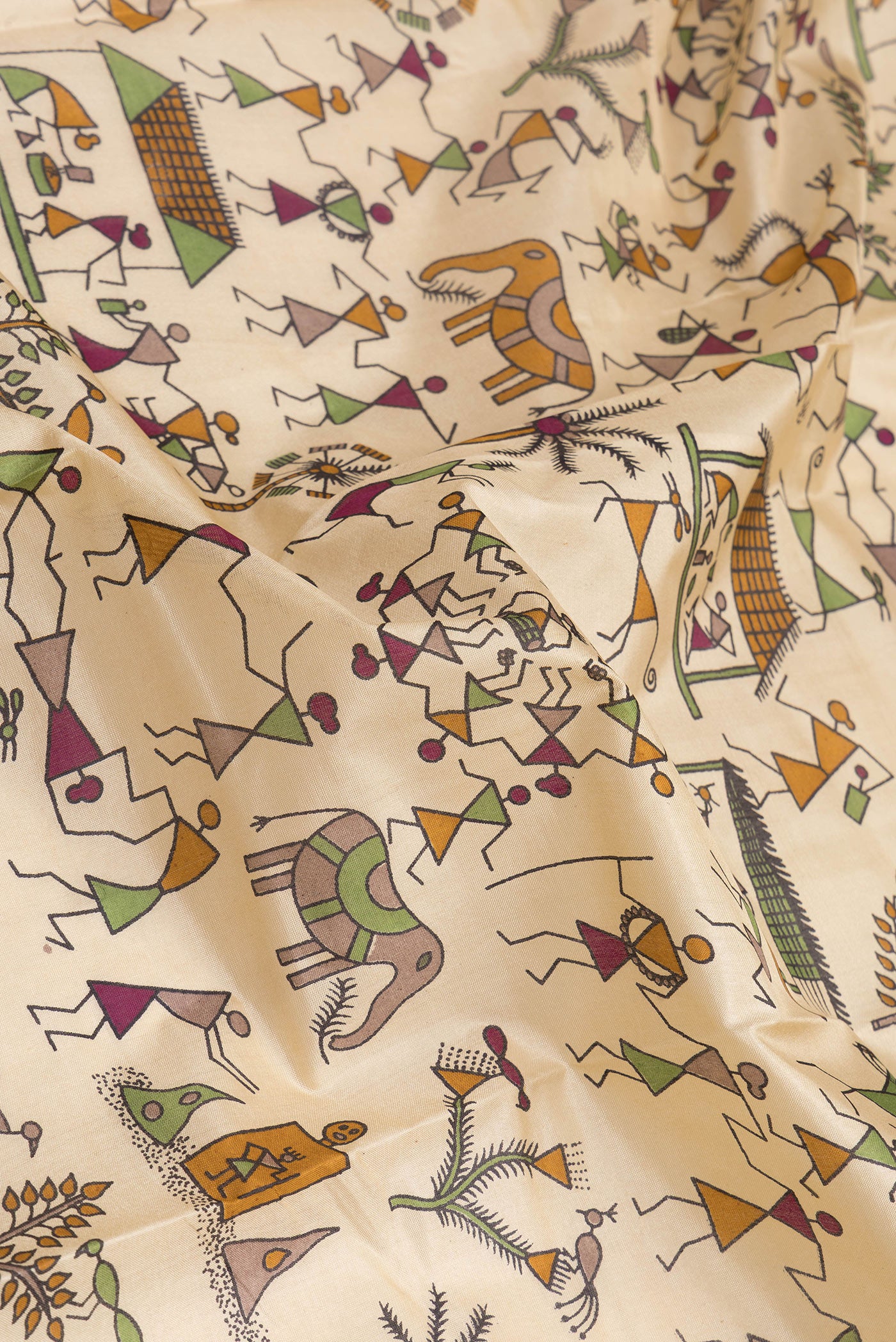 Close up of Beige Dual Tone Tussar Silk Saree with Printed design on the body and Printed Border.  displaying folds