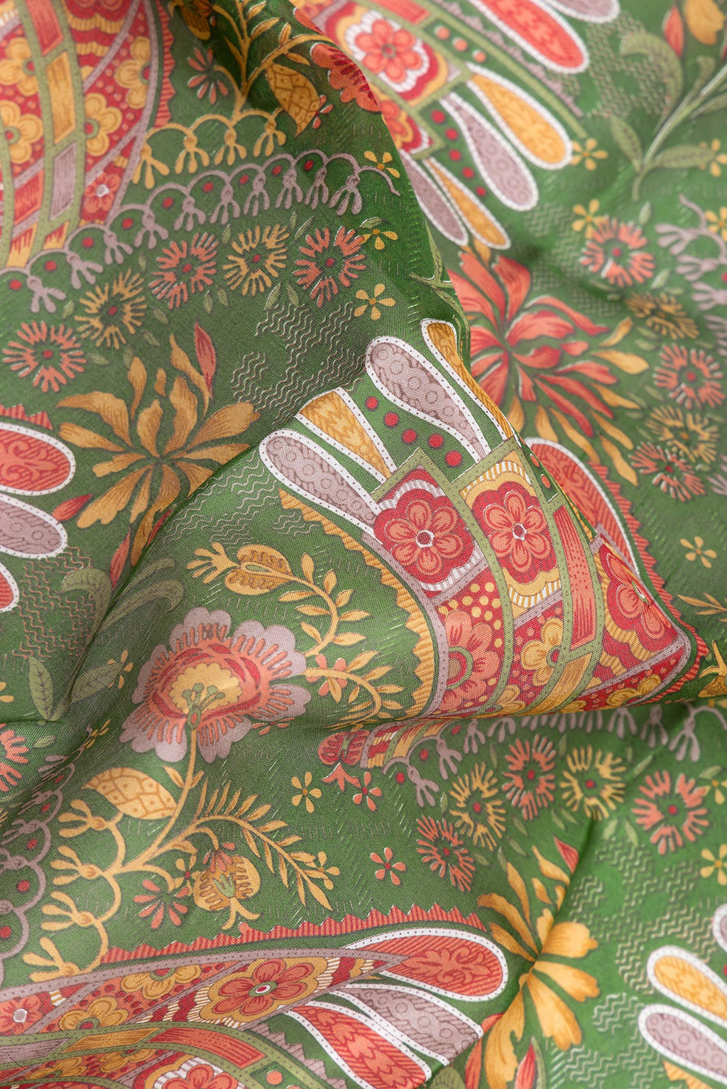 Close up of Green Printed Silk Saree with Printed design on the body and Printed Border.  displaying folds