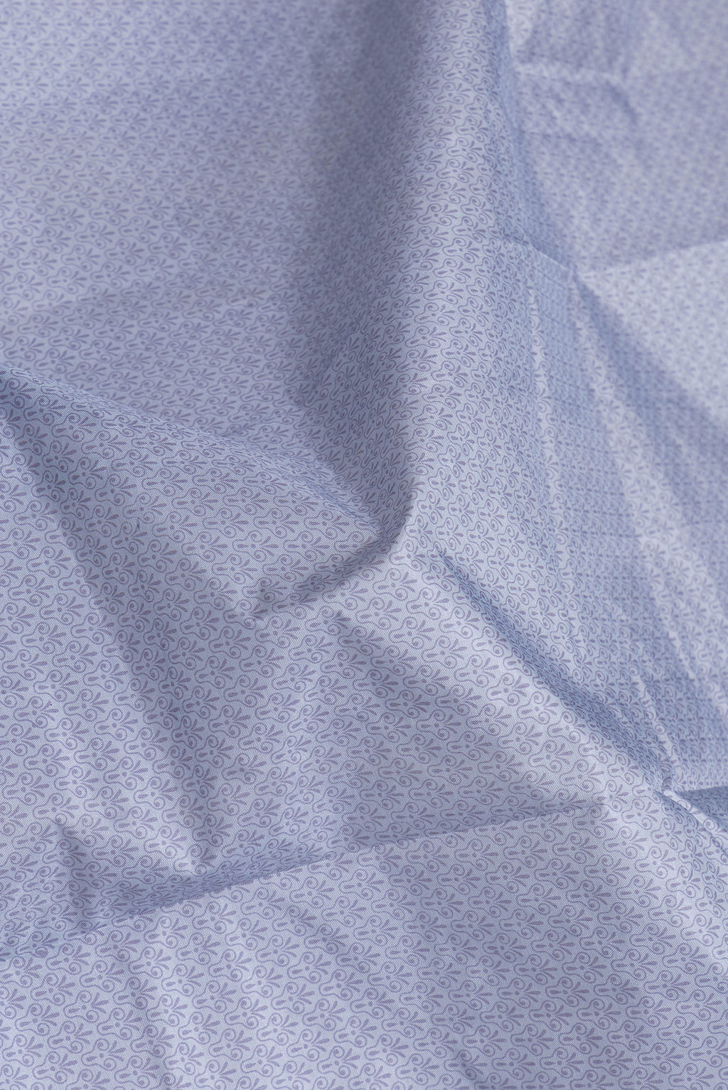 Close up of Grey Dual Tone Tussar Silk Saree with Printed design on the body and Printed Border.  displaying folds