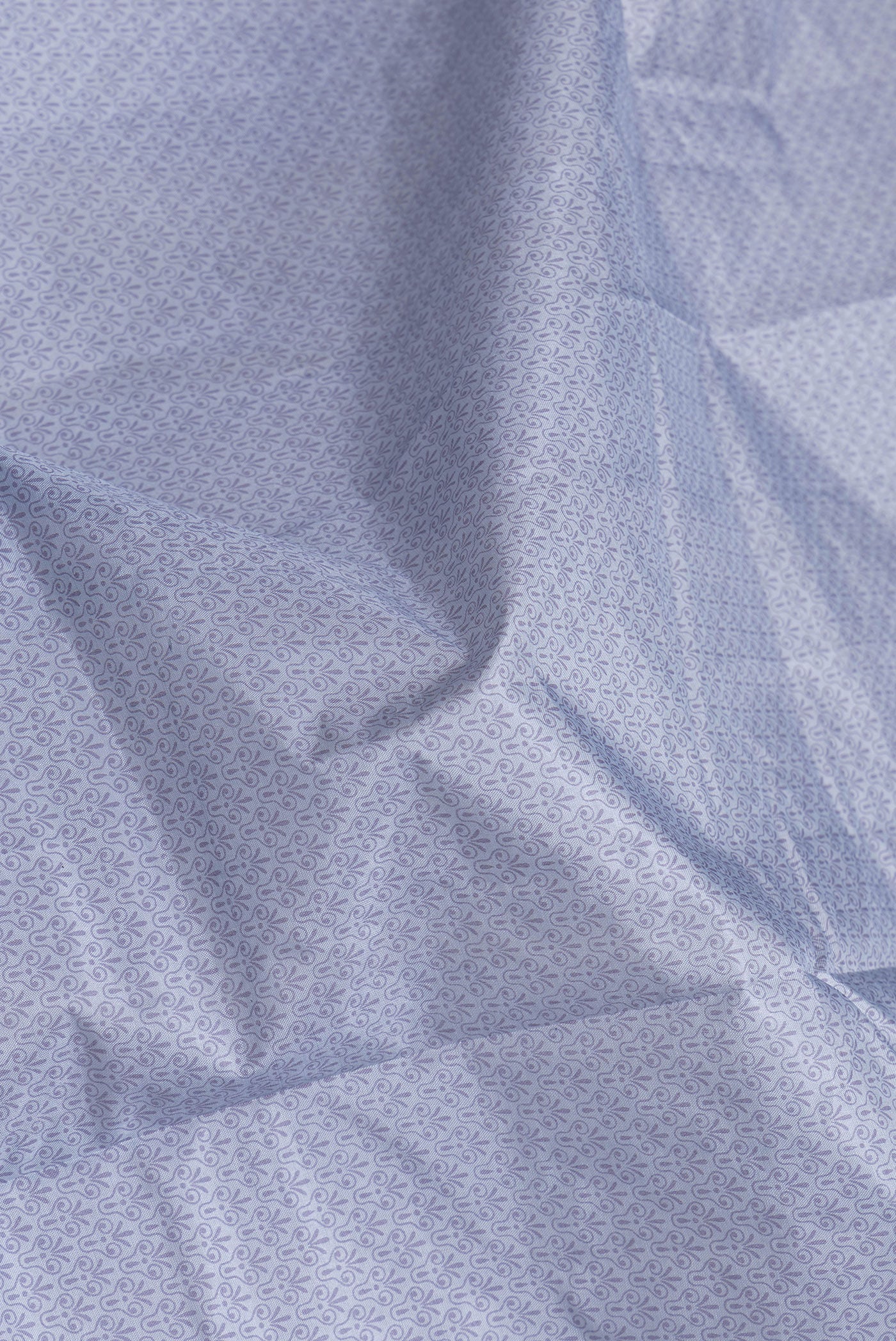 Close up of Grey Dual Tone Tussar Silk Saree with Printed design on the body and Printed Border.  displaying folds