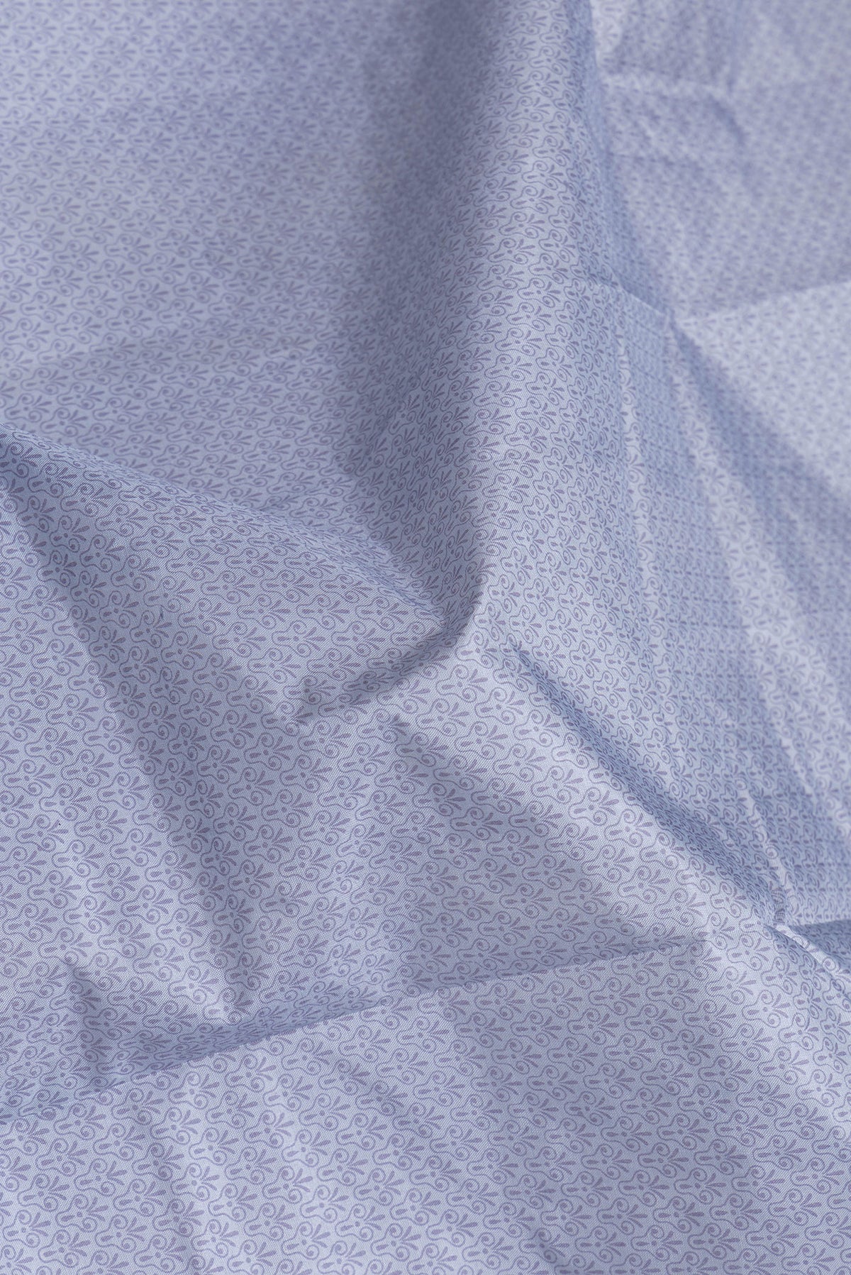 Close up of Grey Dual Tone Tussar Silk Saree with Printed design on the body and Printed Border.  displaying folds