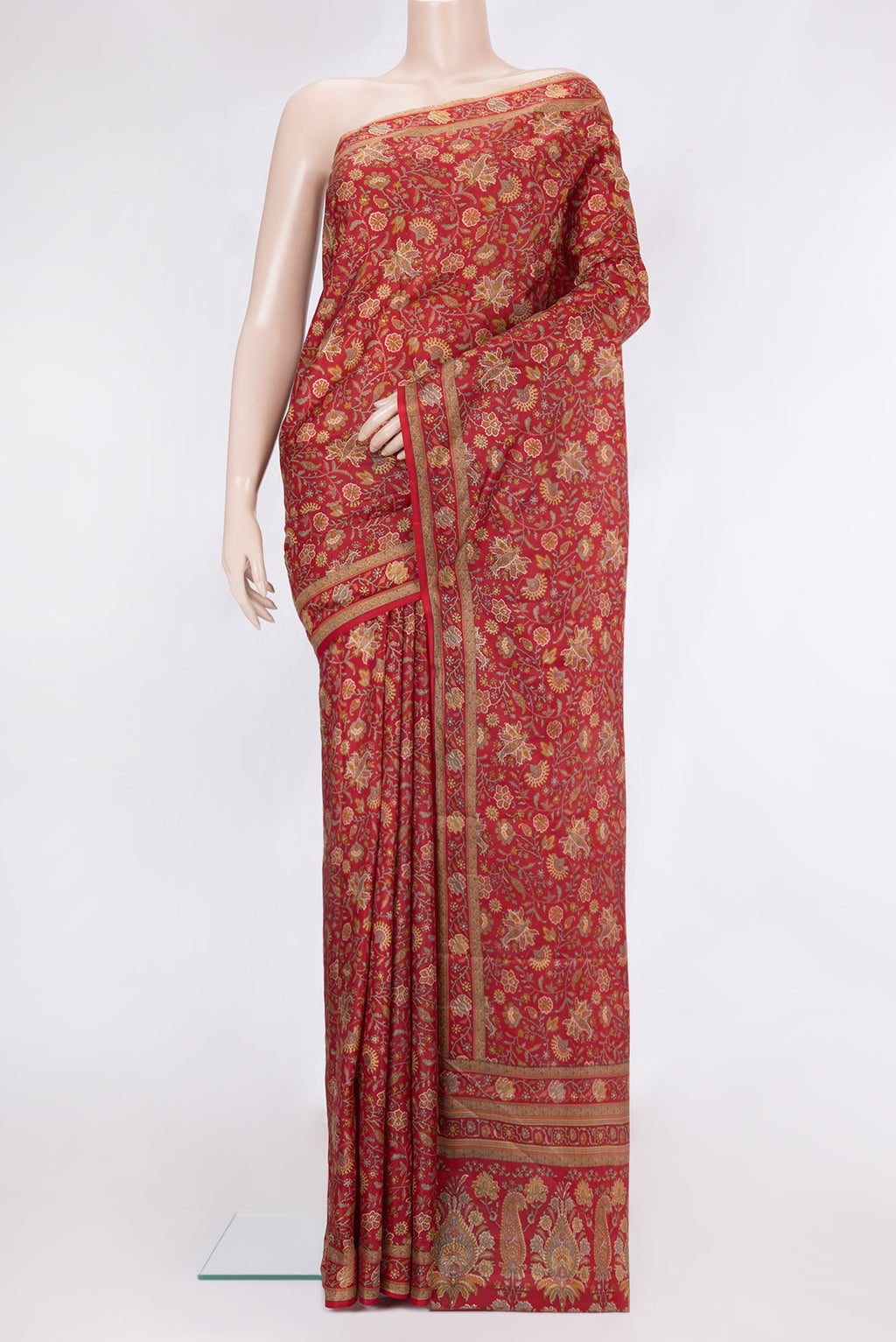 Maroon Printed Silk Saree with Printed design on the body and Printed Border.  displayed on a mannequin