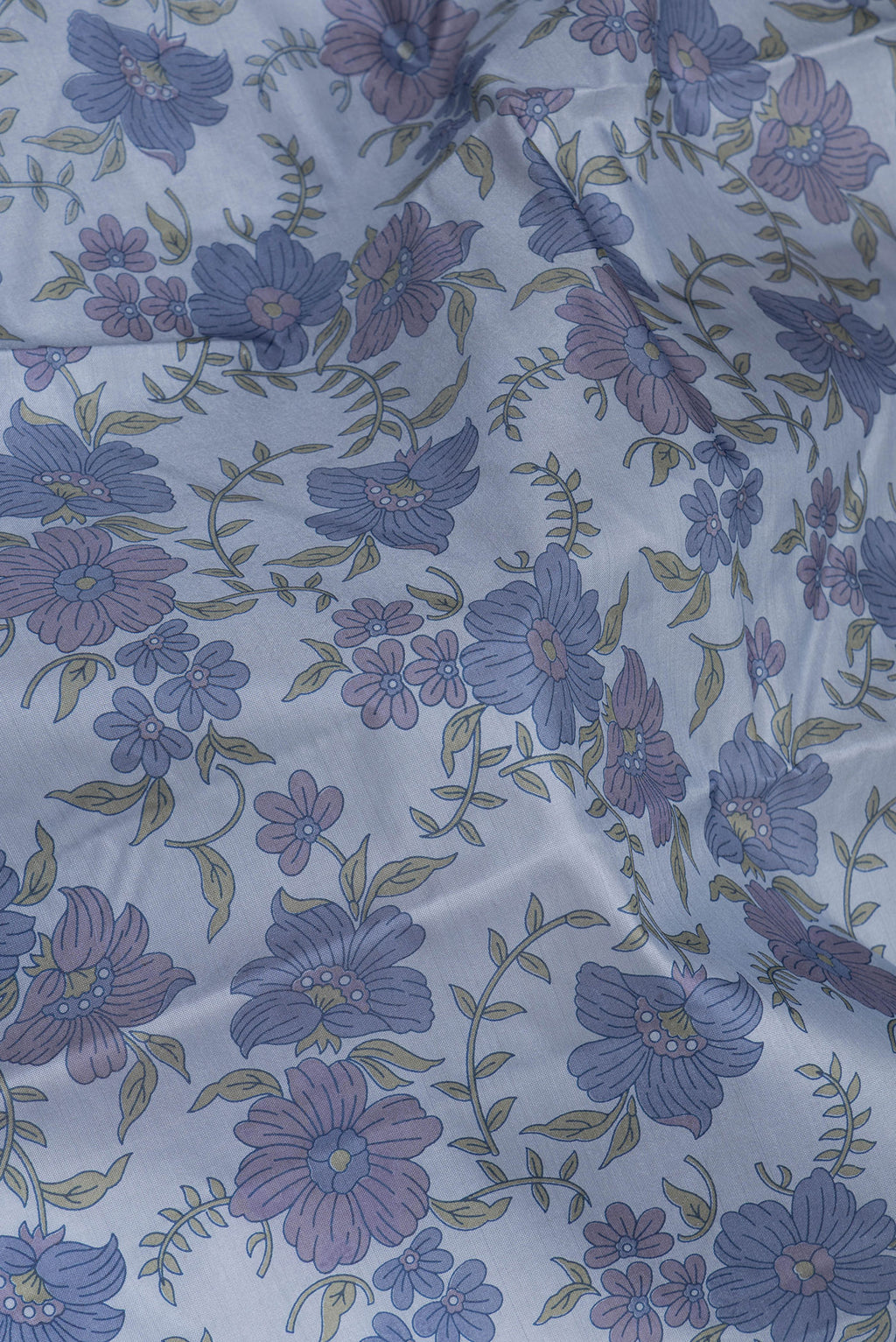 Close up of Grey Printed Silk Saree with Printed design on the body and Without Border.  displaying folds