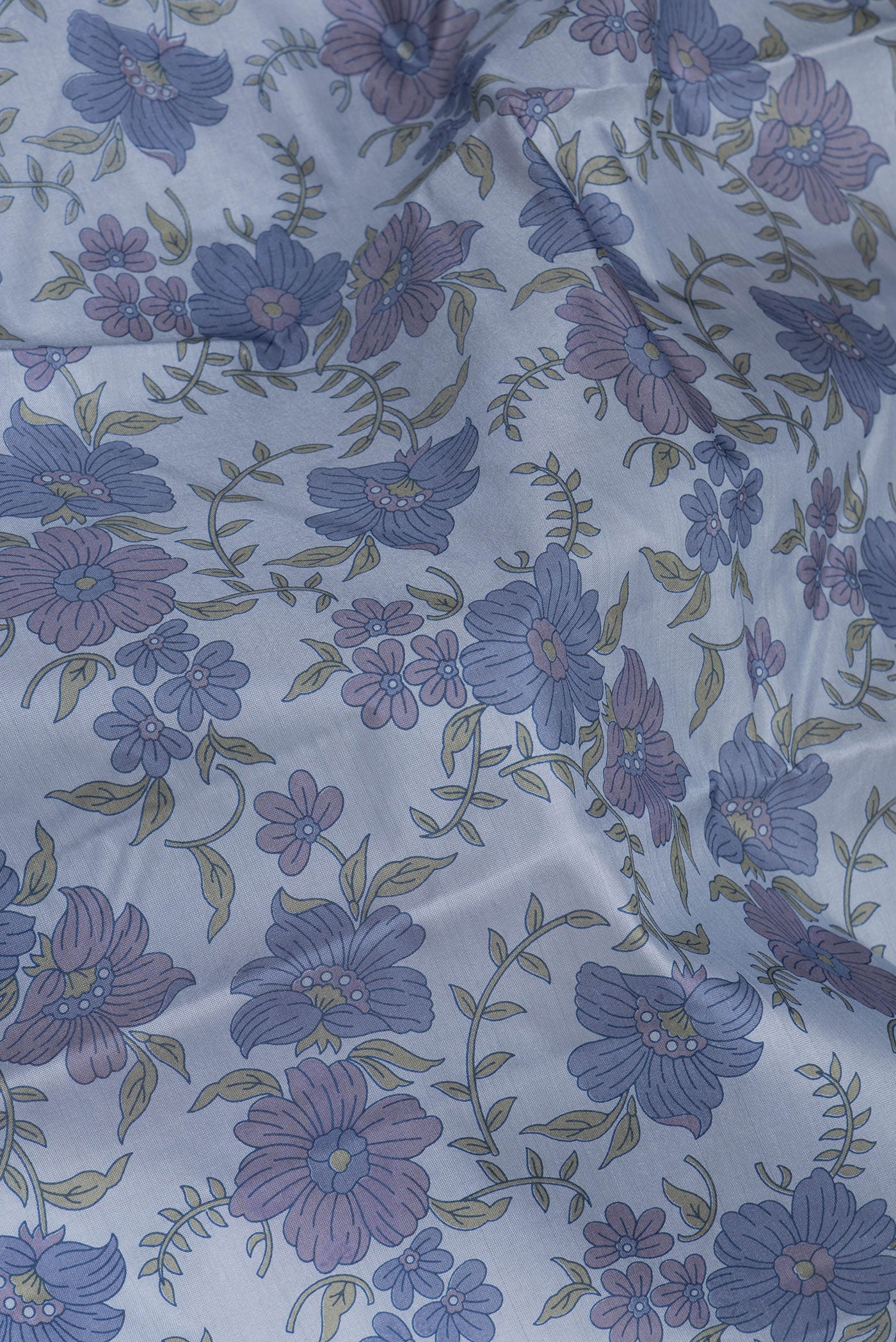 Close up of Grey Printed Silk Saree with Printed design on the body and Without Border.  displaying folds