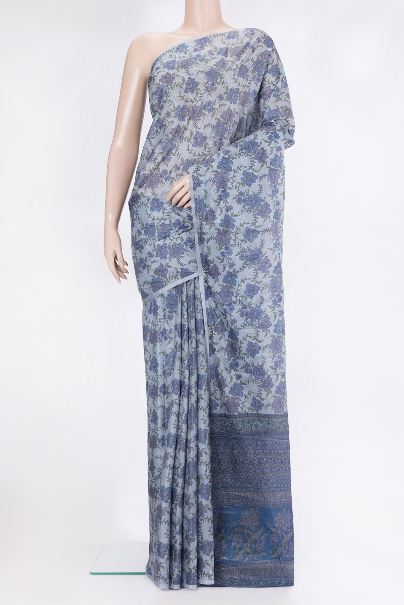 Grey Printed Silk Saree with Printed design on the body and Without Border.  displayed on a mannequin