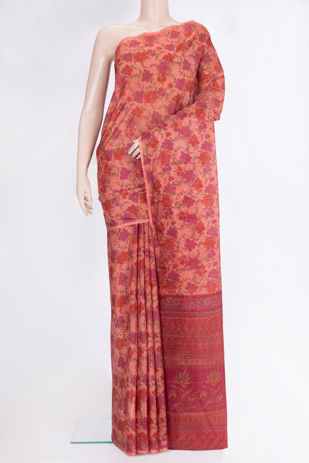Coral Printed Silk Saree with Printed design on the body and Without Border.  displayed on a mannequin