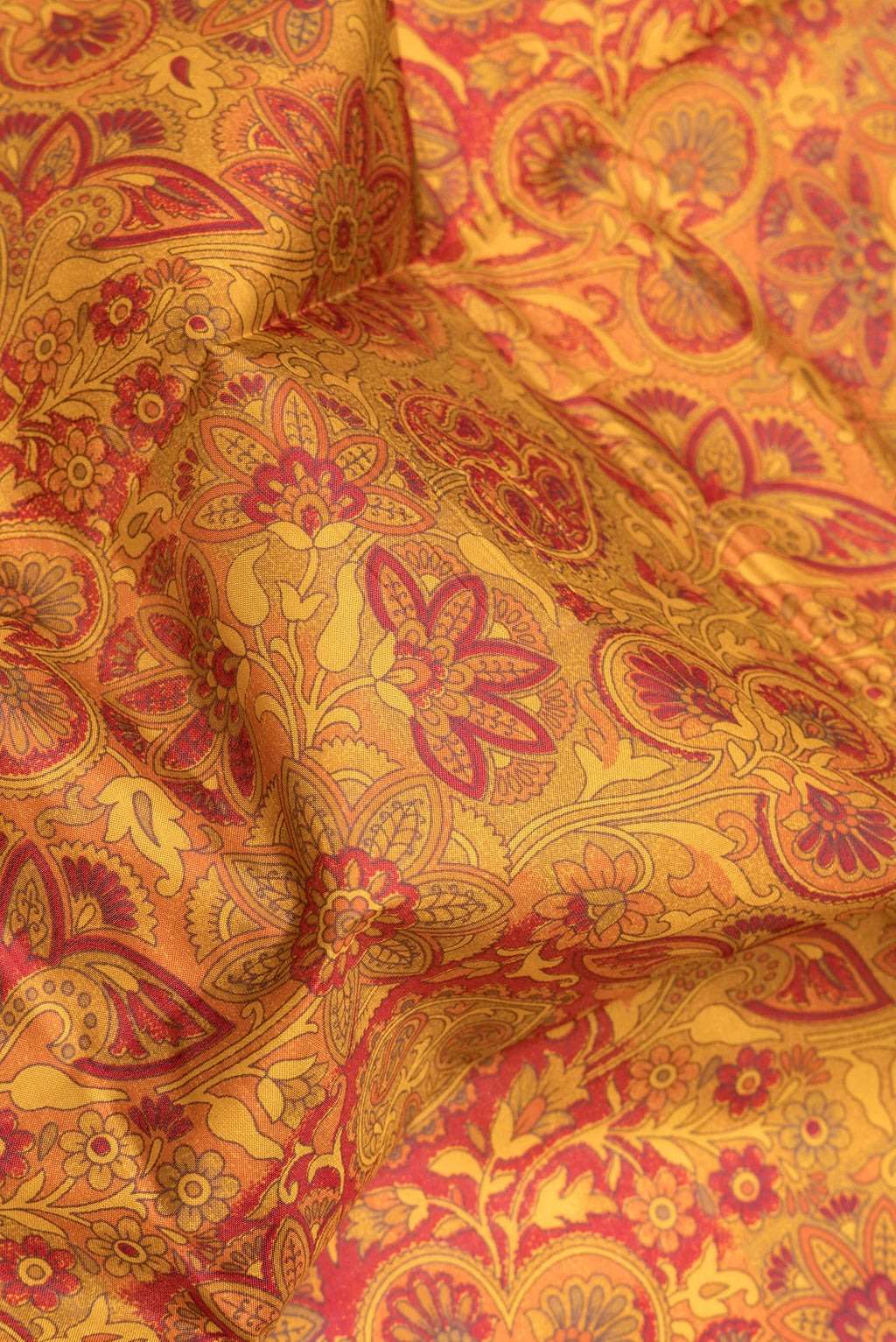 Close up of Mustard Printed Silk Saree with Printed design on the body and Printed Border.  displaying folds