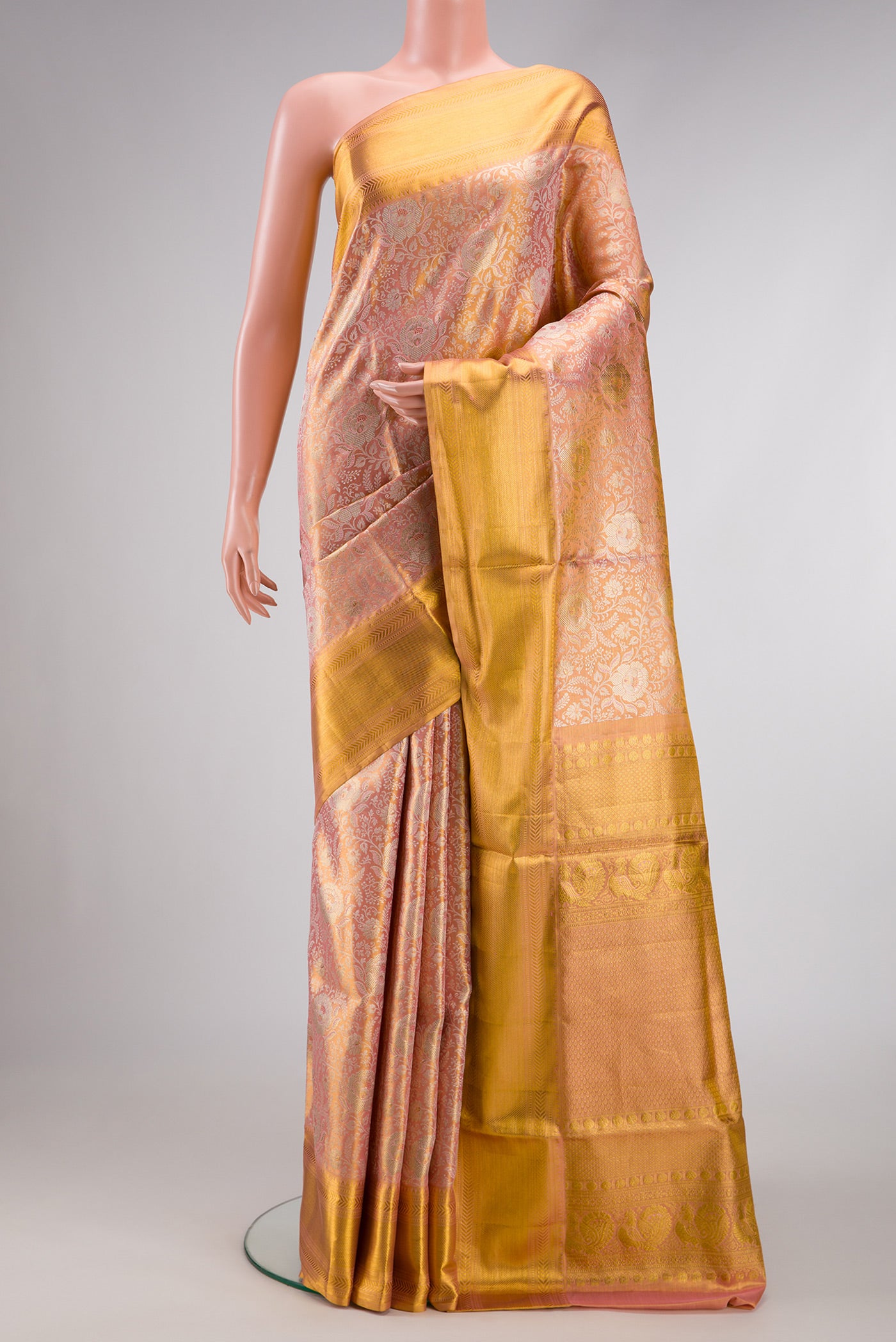 Rose Gold Dual Tone Kanjivaram Tissue Silk Saree with Zari Brocade on the body and Zari Border.  displayed on a mannequin