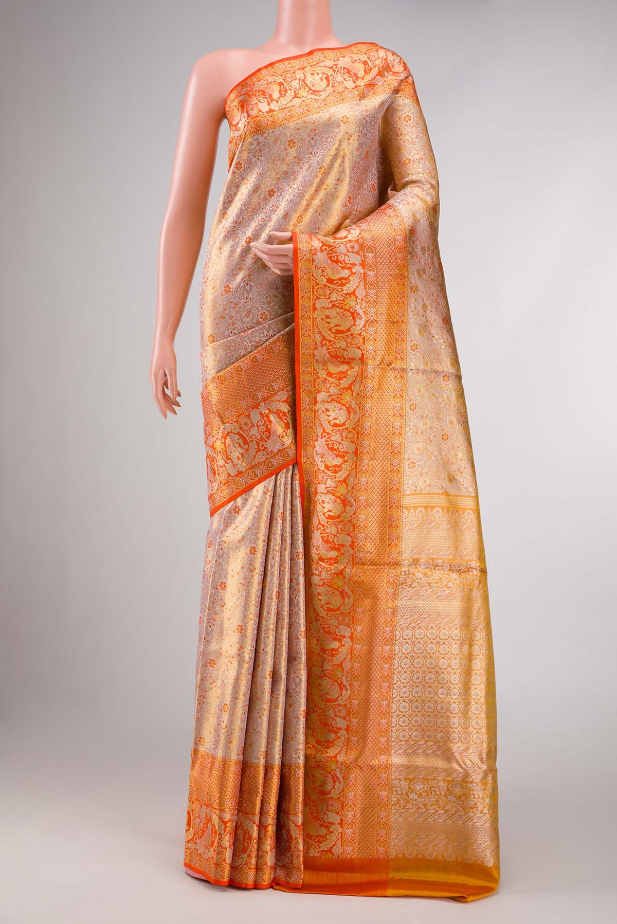 Gold Dual Tone Kanchipuram Silk Saree with Zari Brocade on the body and Zari Border displayed on a mannequin