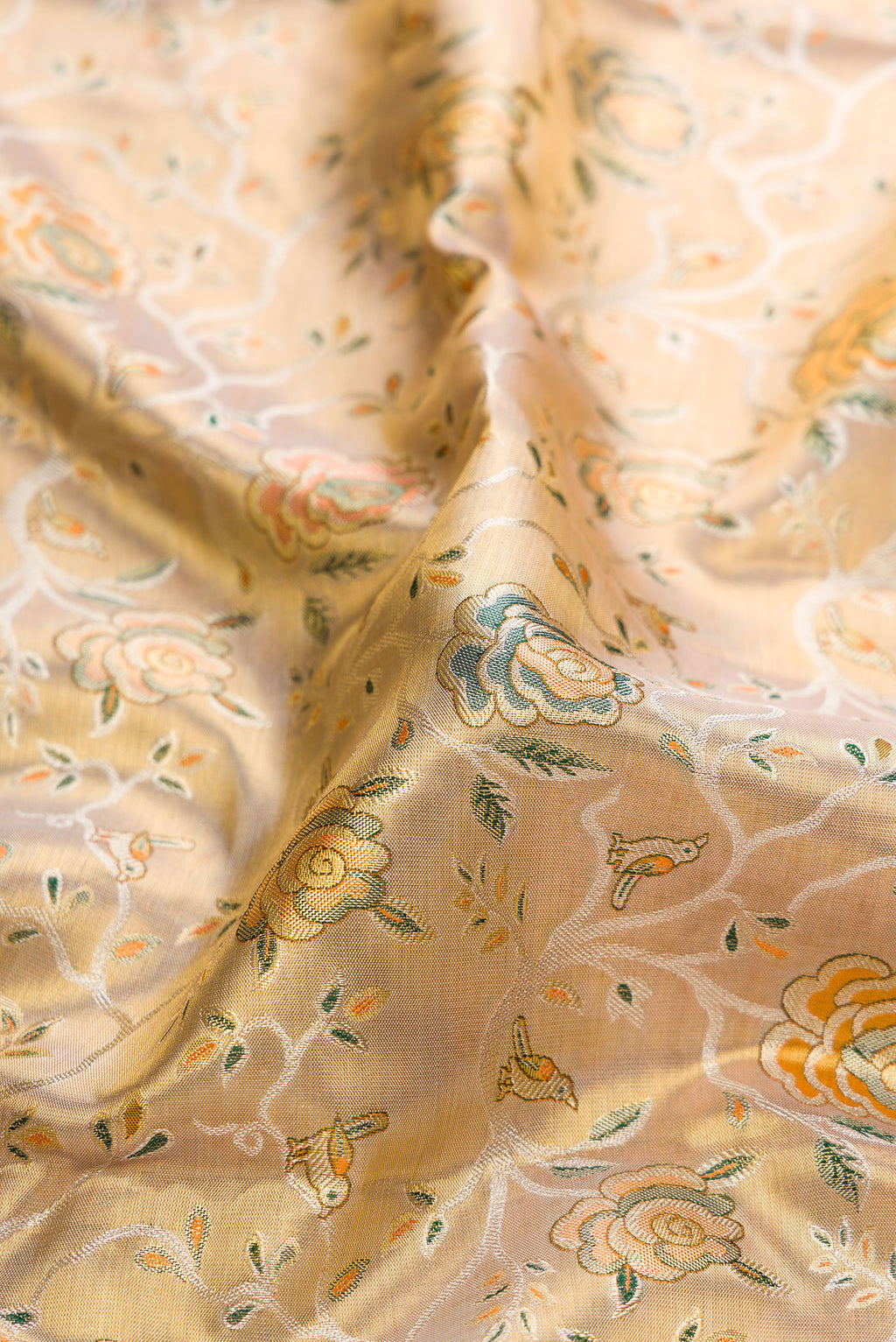 Close up of Gold Dual Tone Kanchipuram Tissue Silk Saree with Zari Brocade on the body and Zari Border.  displaying folds