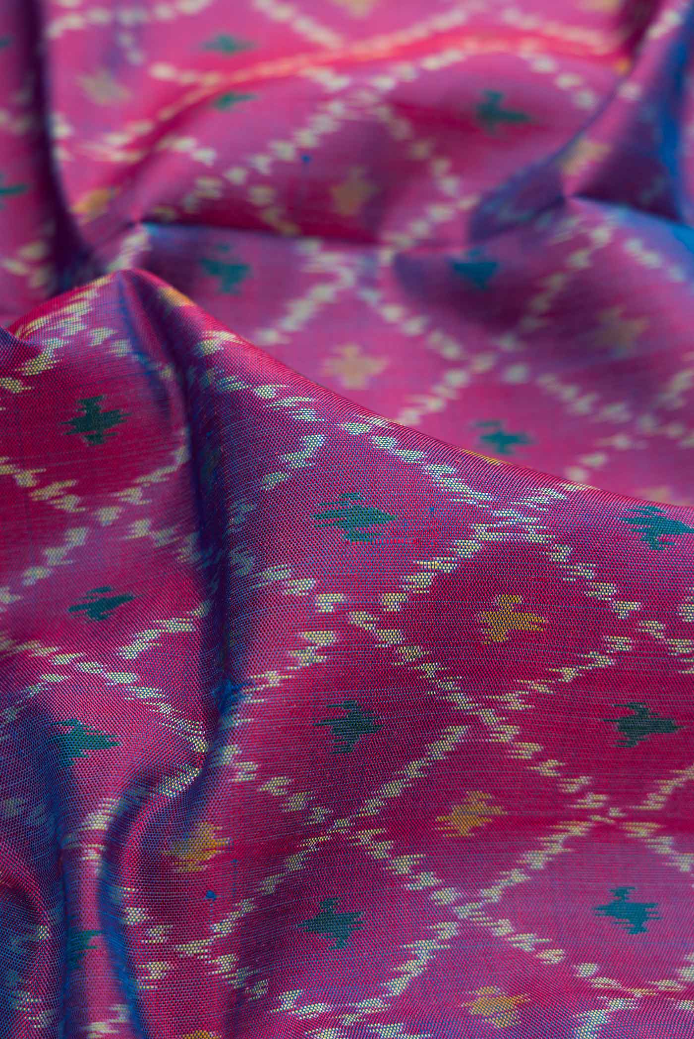 Close up of Purple Dual Tone Double Ikat Saree with Ikat Print on the body and Zari Border.  displaying folds