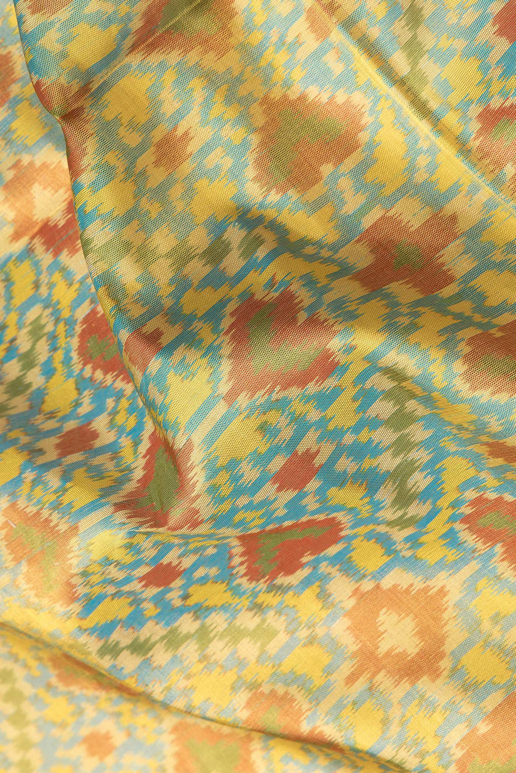 Close up of Sky Blue Dual Tone Double Ikat Saree with Ikat Print on the body and Zari Border.  displaying folds