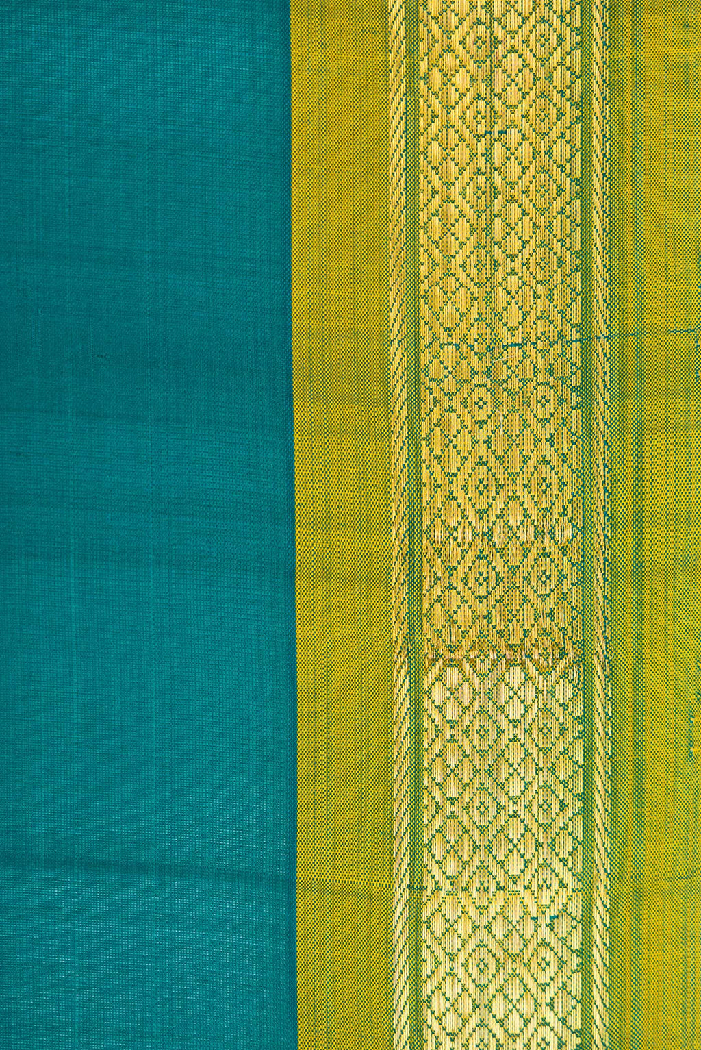 Border image of Peacock Blue Dual Tone Kanchipuram Silk Saree with Plain Body and Zari Border. 