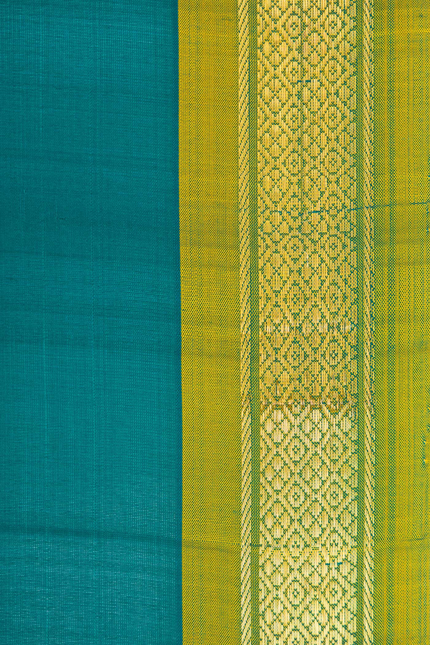 Border image of Peacock Blue Dual Tone Kanchipuram Silk Saree with Plain Body and Zari Border. 