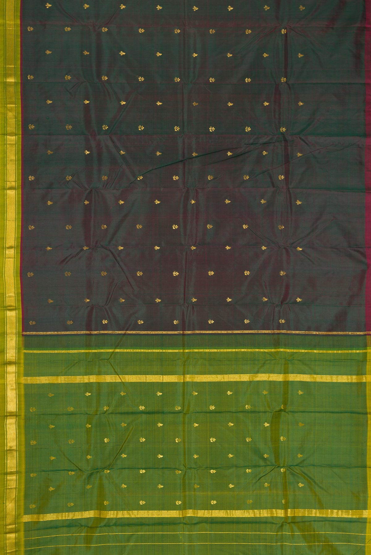 Bottle Green Dual Tone Kanchipuram Silk Saree with Zari Butta on the body and Zari Border.  displayed on a mannequin