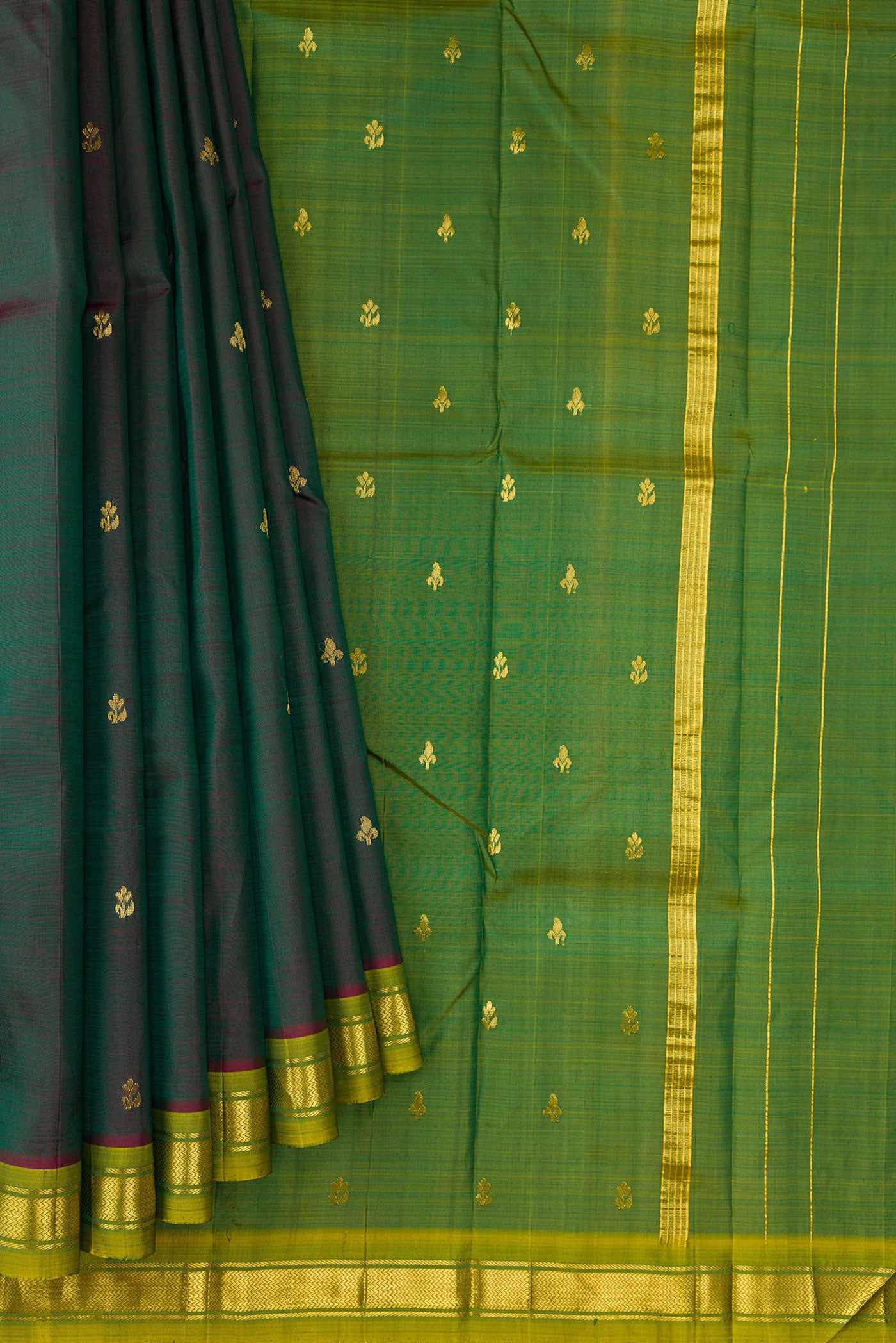 Pleats and pallu of Bottle Green Dual Tone Kanchipuram Silk Saree with Zari Butta on the body and Zari Border. 
