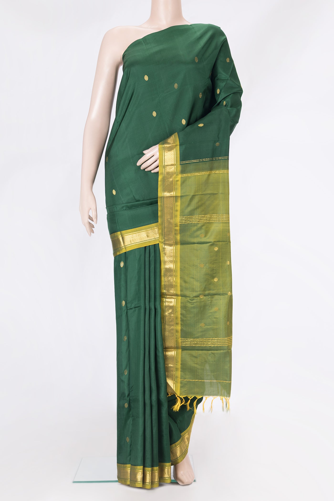 Bottle Green Kanchipuram Silk Saree with Zari Butta on the body and One Side Border.  displayed on a mannequin
