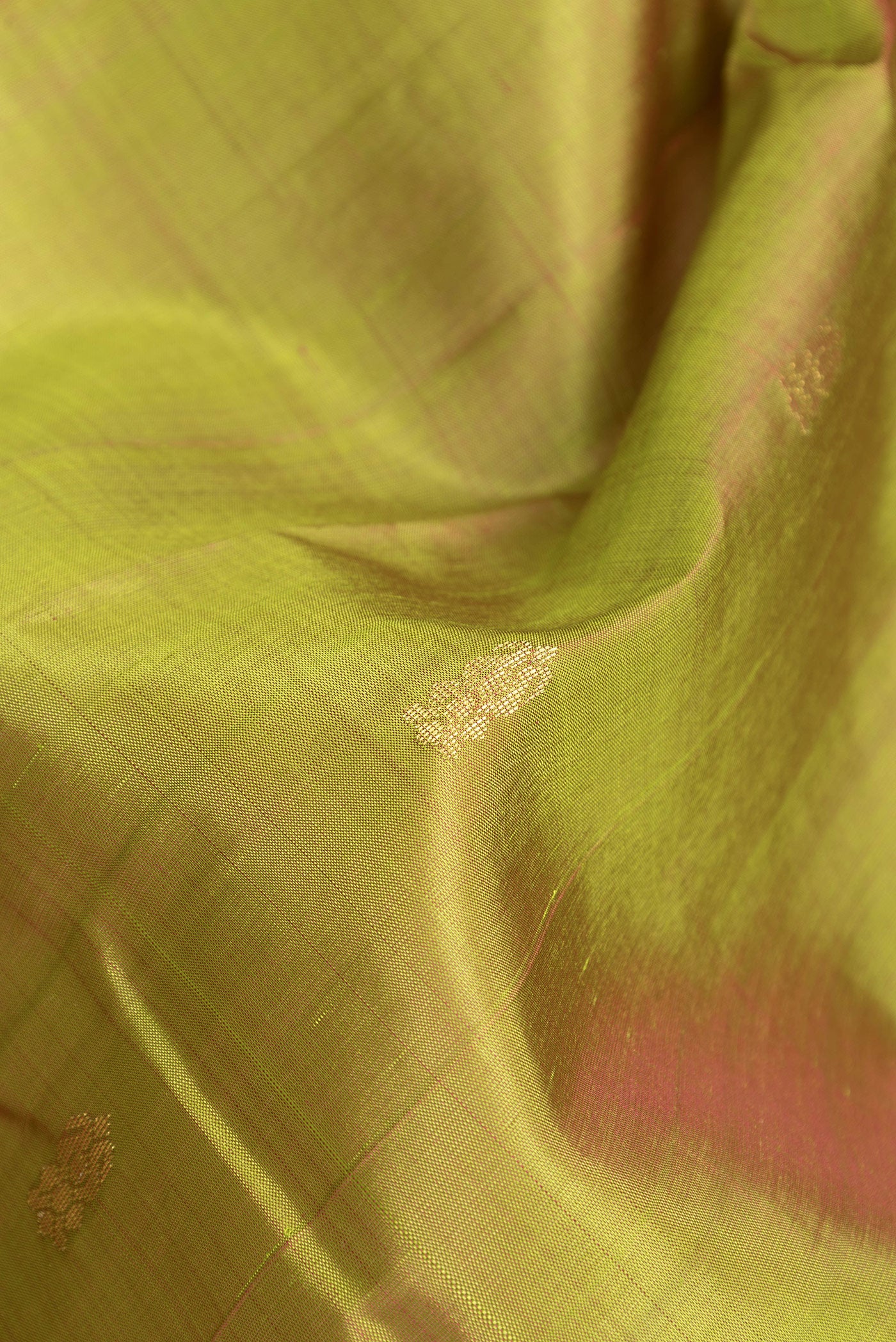 Close up of Mehandi Green Dual Tone Kanjivaram Silk Saree with Zari Butta on the body and One Side Border.  displaying folds